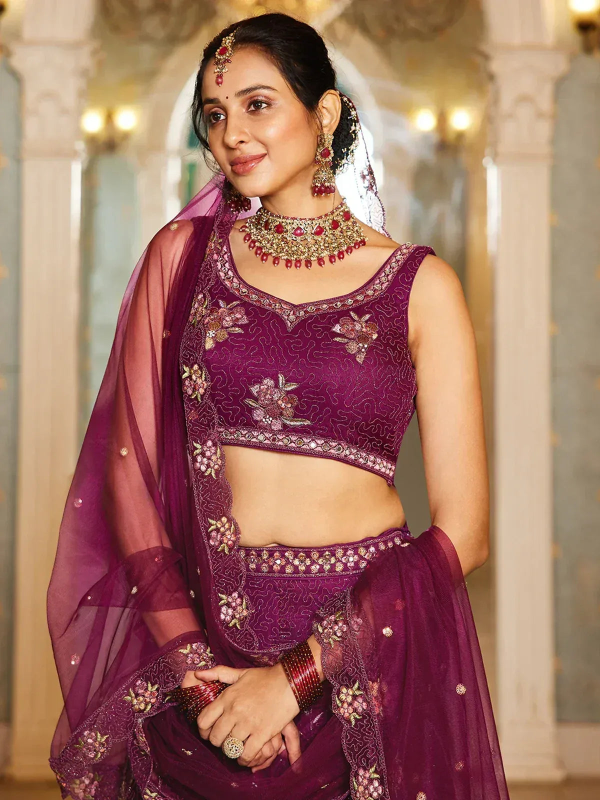 Purple embroidered lehenga choli with floral motifs, perfect for Indian weddings and festive occasions.