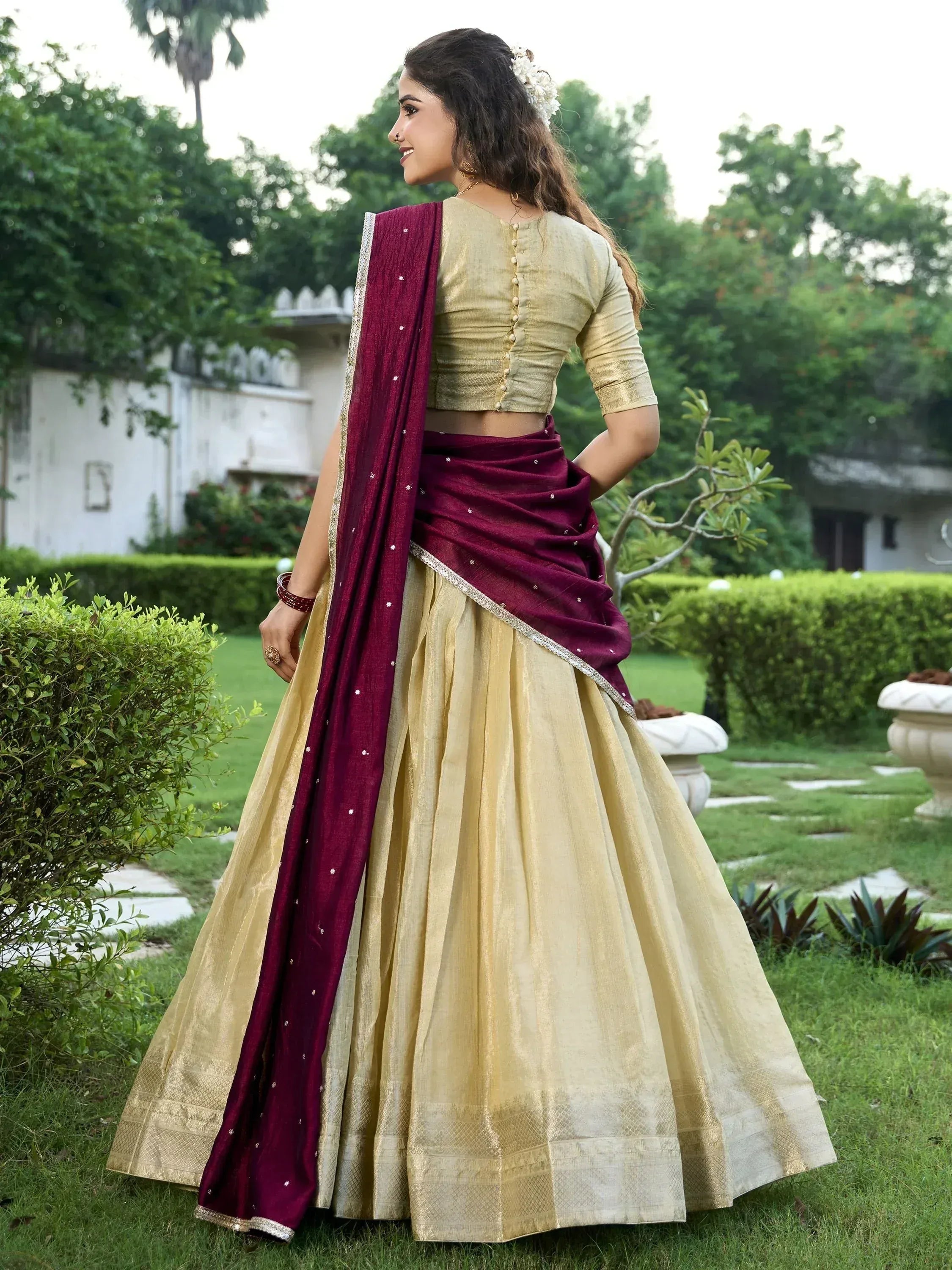 Elegant gold lehenga choli with maroon dupatta, perfect for Indian ethnic wear occasions