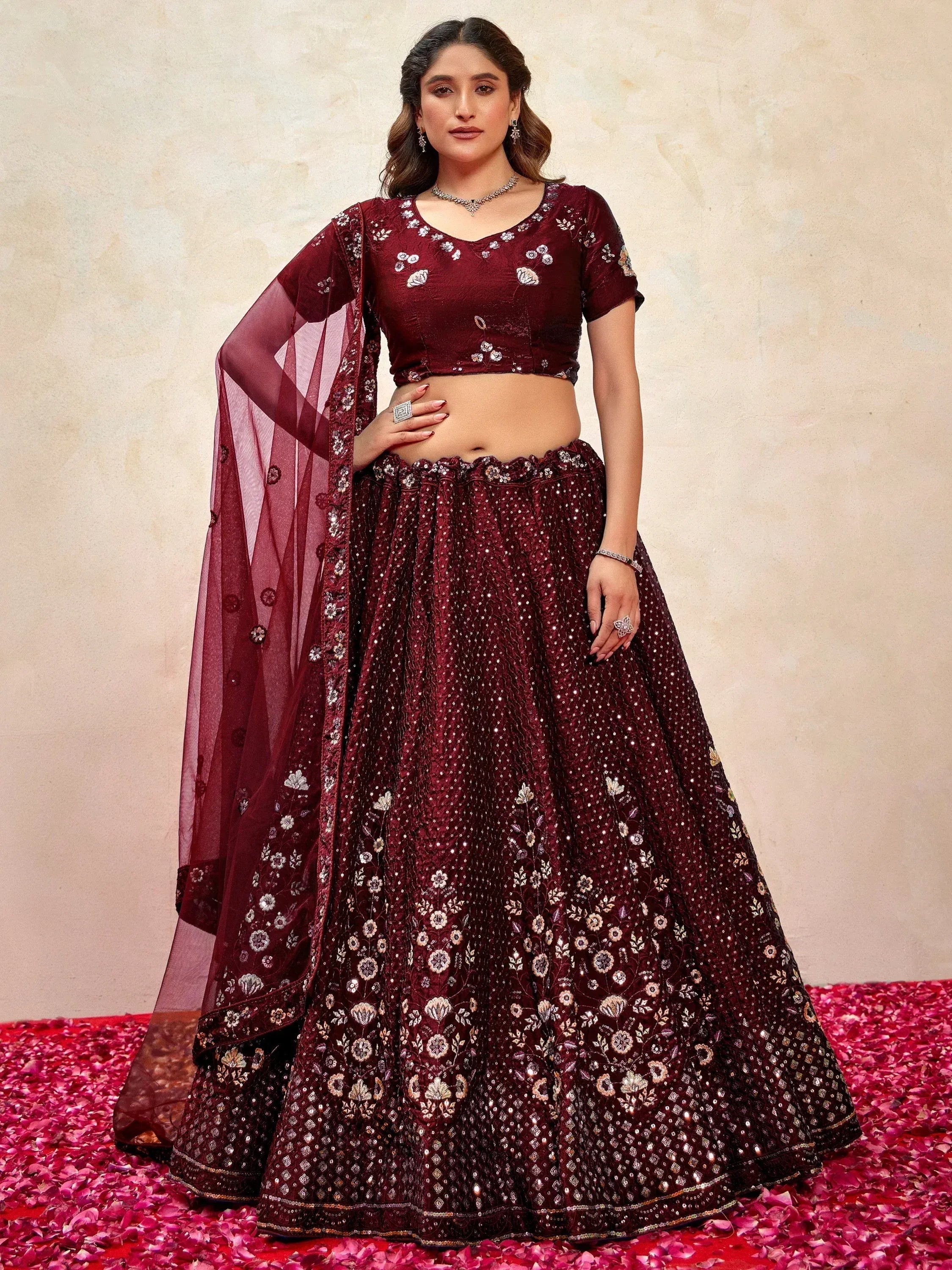 Maroon designer lehenga choli with floral embroidery and sequins, perfect for weddings and festive occasions.