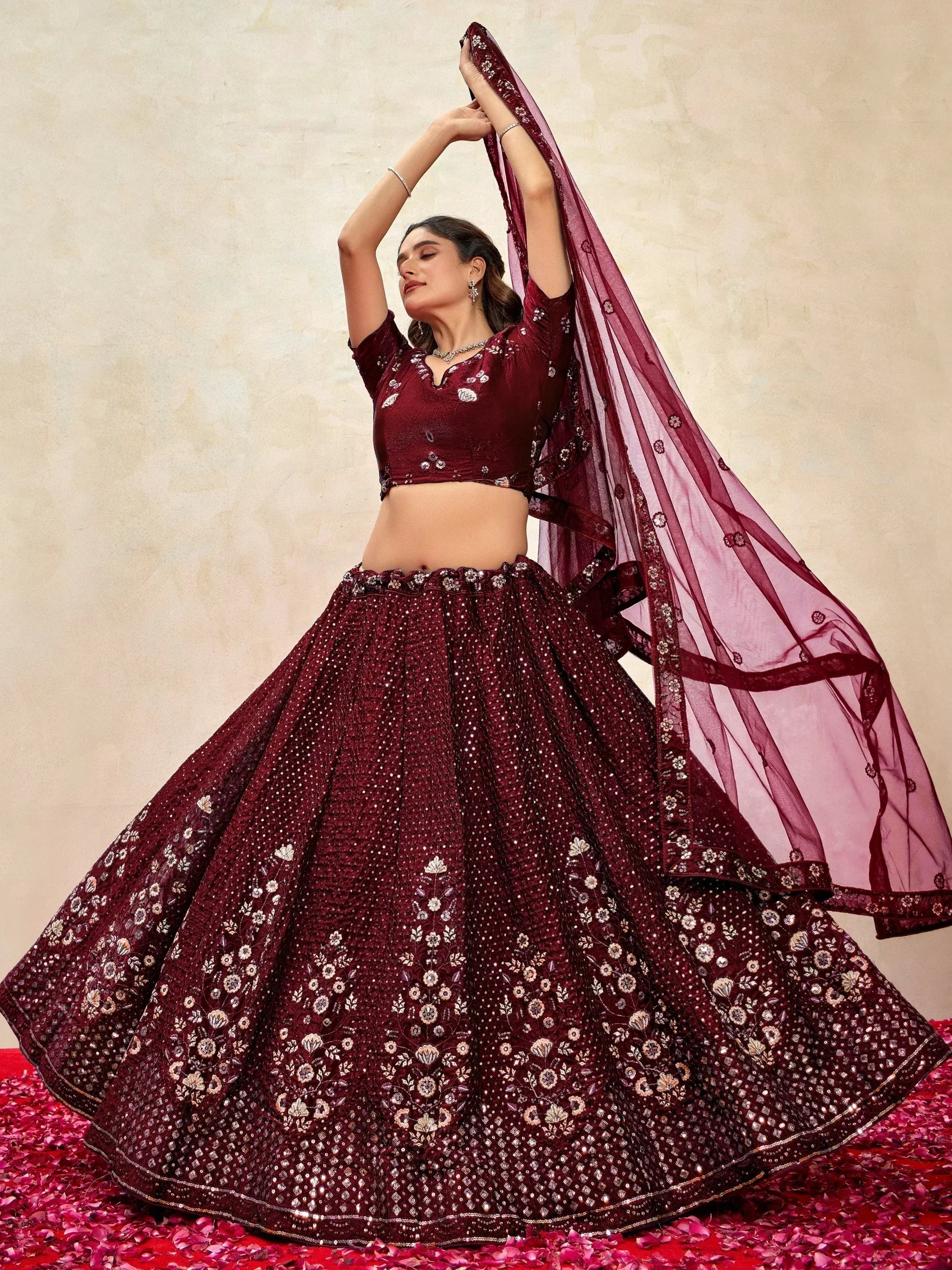 Maroon embroidered lehenga choli with floral motifs and sheer dupatta, perfect for Indian weddings and festive occasions.