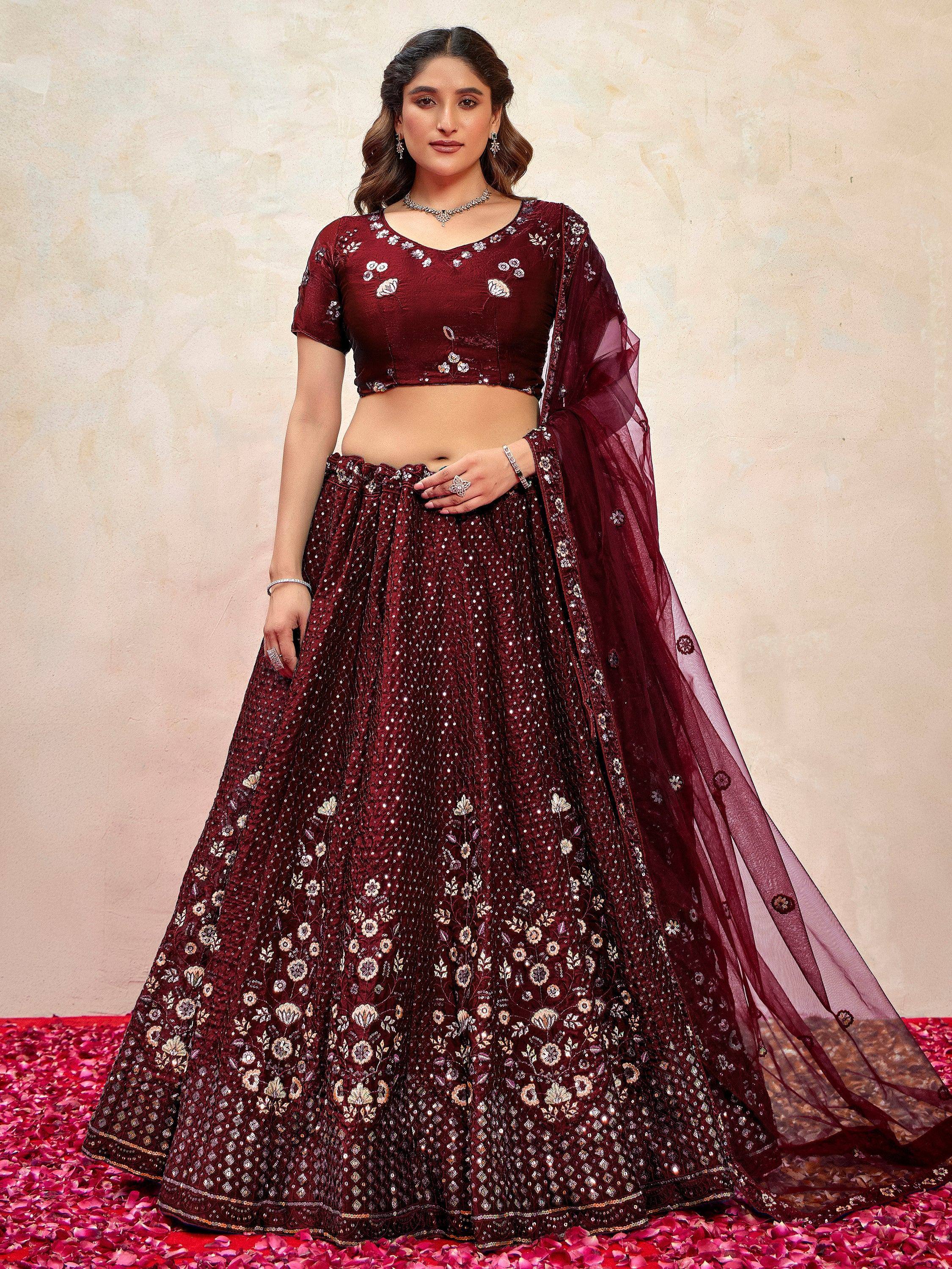Maroon embroidered lehenga choli with floral motifs and sheer dupatta, ideal for Indian weddings and festive occasions.