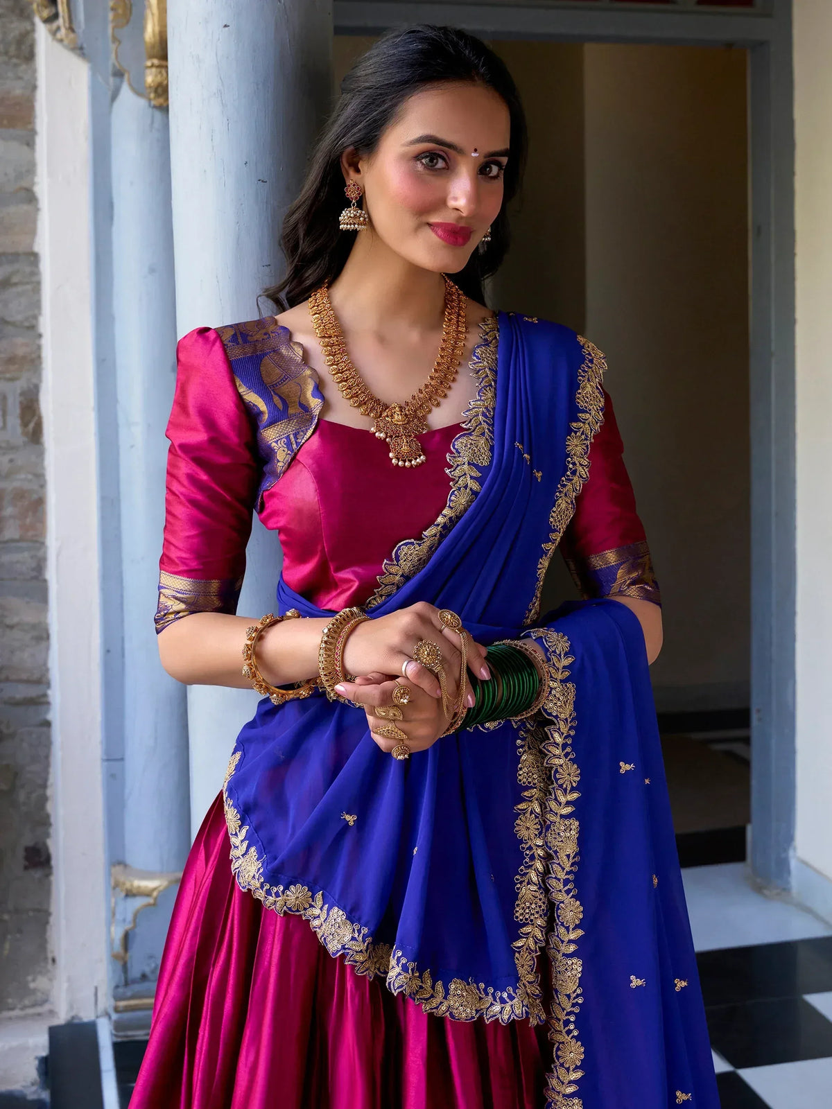 Royal blue and magenta Indian lehenga choli with gold embroidery, perfect for weddings and festivals.