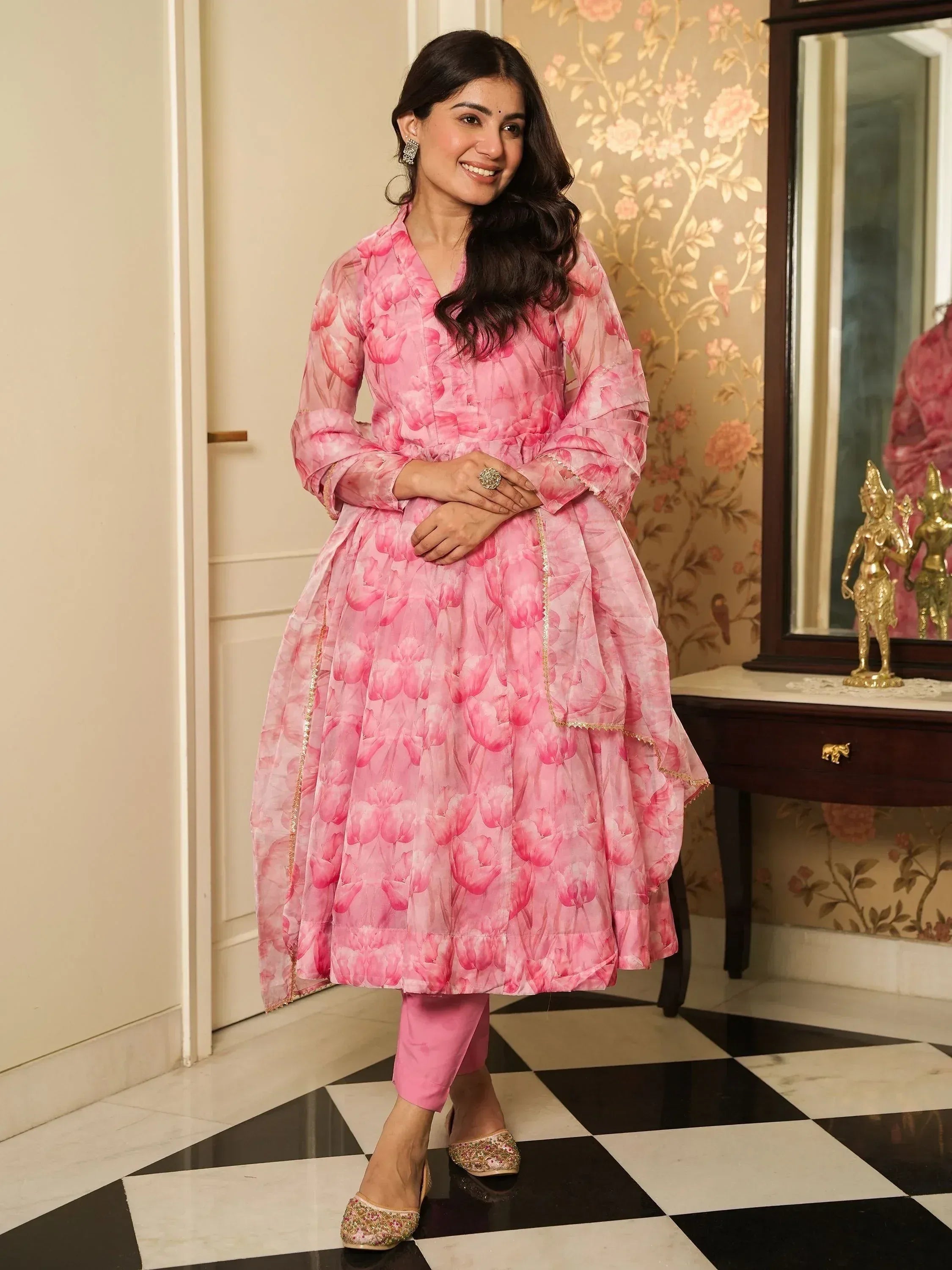 Pink floral print Anarkali suit with matching pants and embellished flats, perfect for ethnic occasions.