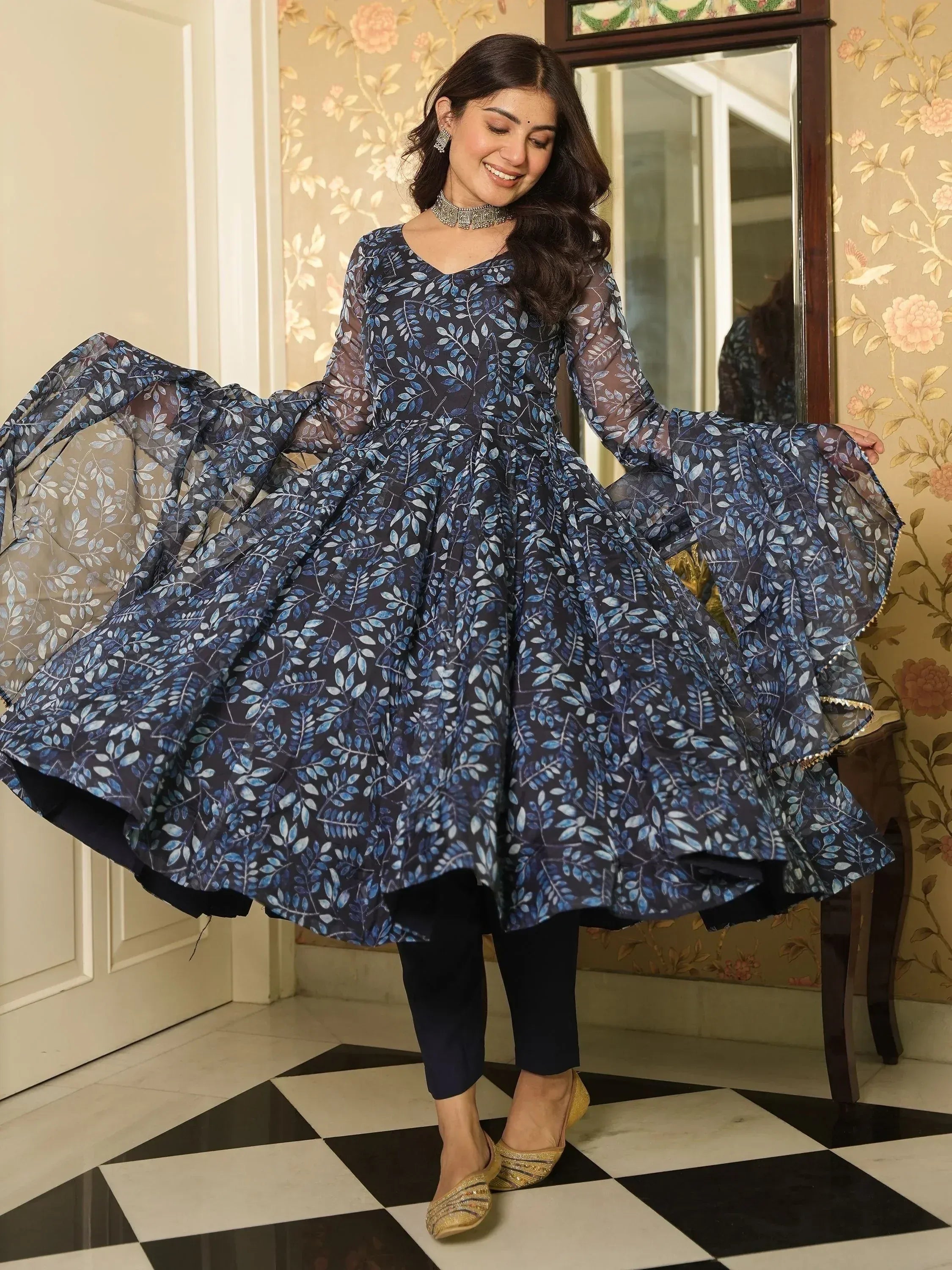 Blue leaf-print ethnic gown with flared sleeves and black pants, perfect for festive occasions.