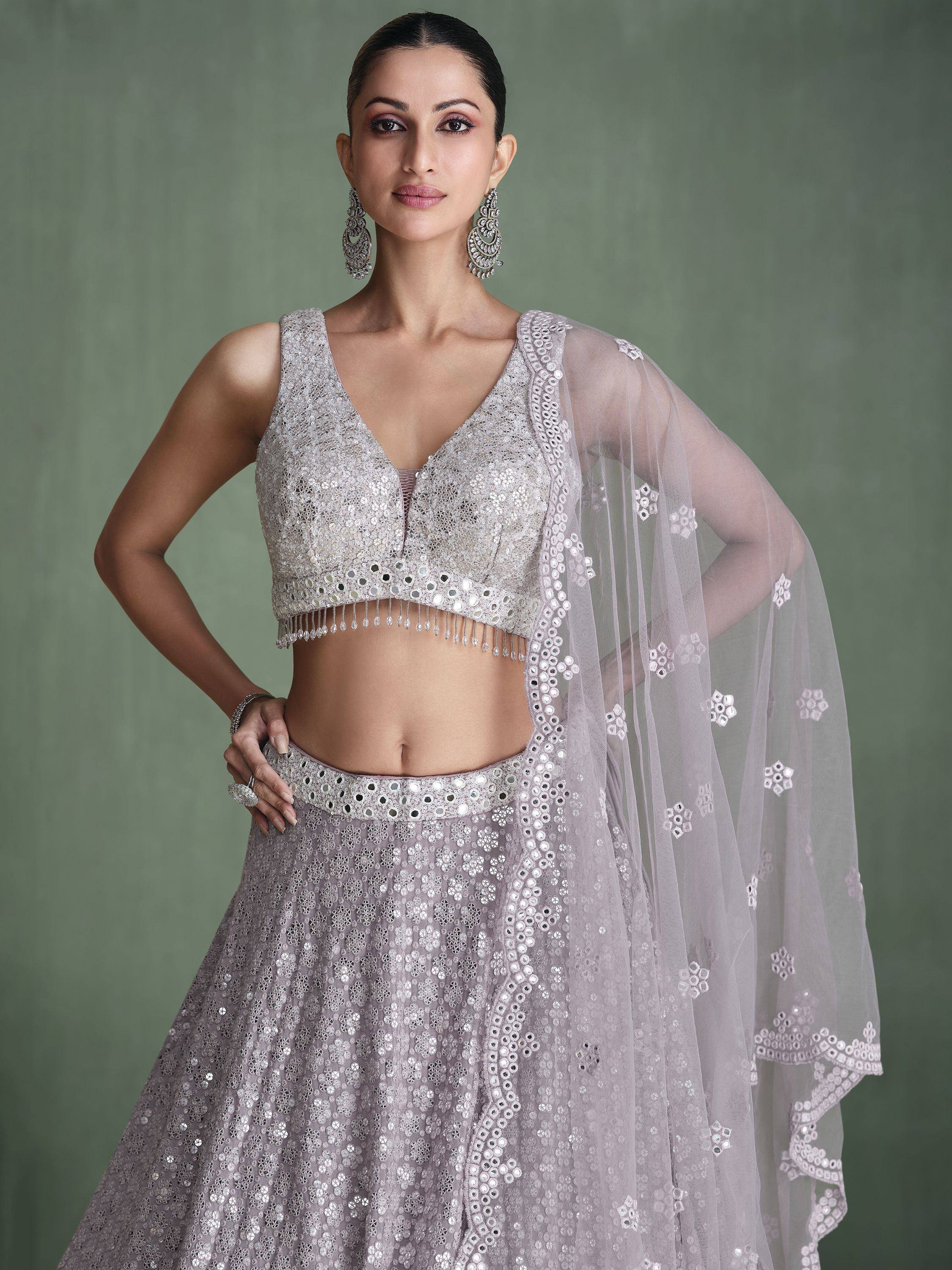 Elegant lavender lehenga choli with mirror work and sheer dupatta, perfect for Indian ethnic occasions