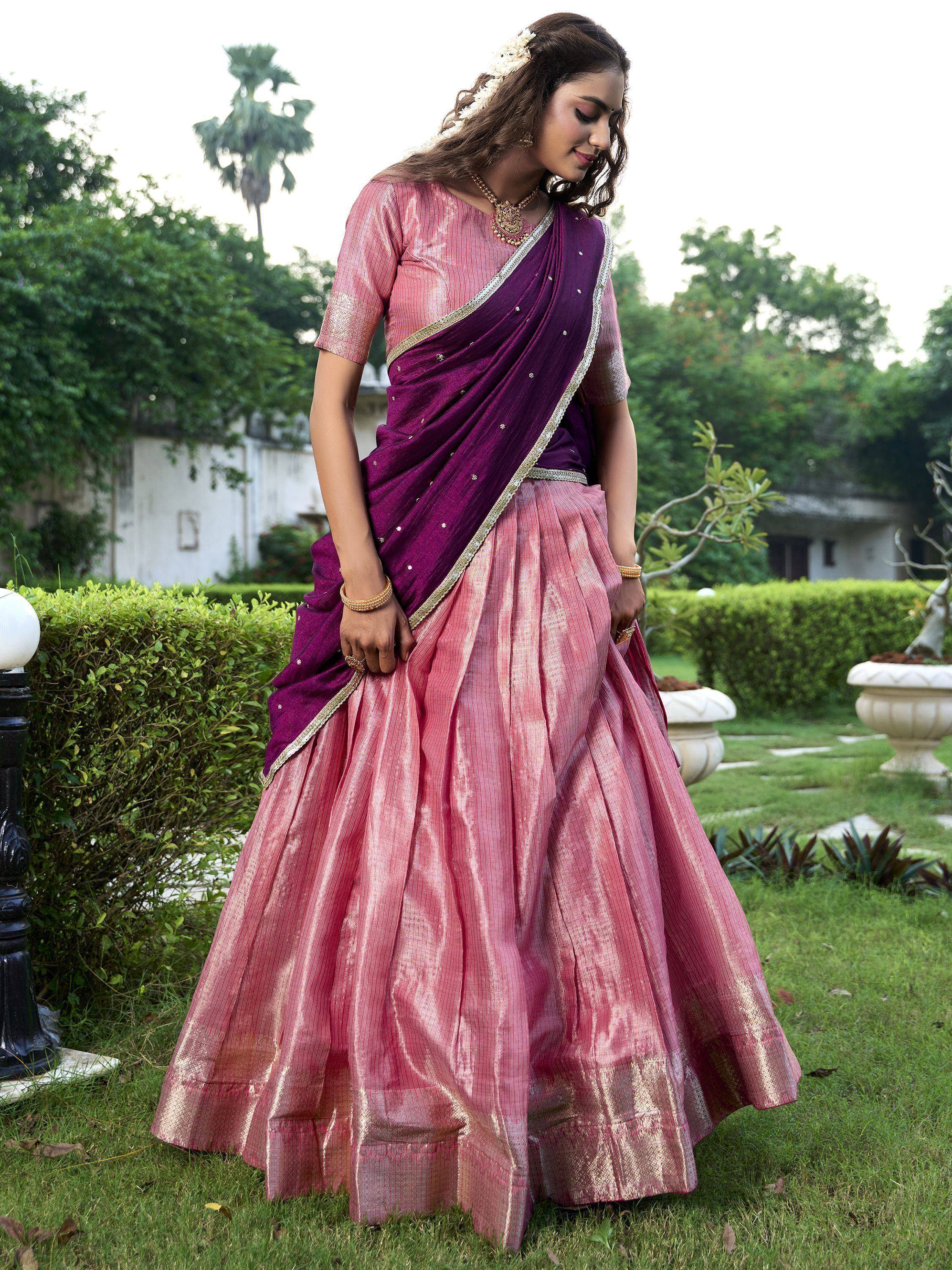 Woman in pink and purple designer lehenga choli with gold trim, perfect for Indian ethnic wear events