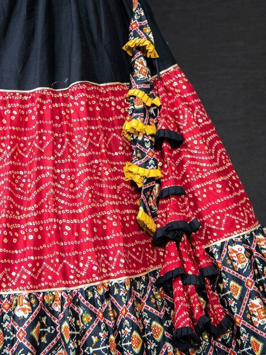 Red and black ethnic lehenga with intricate bandhani print and ruffled detailing