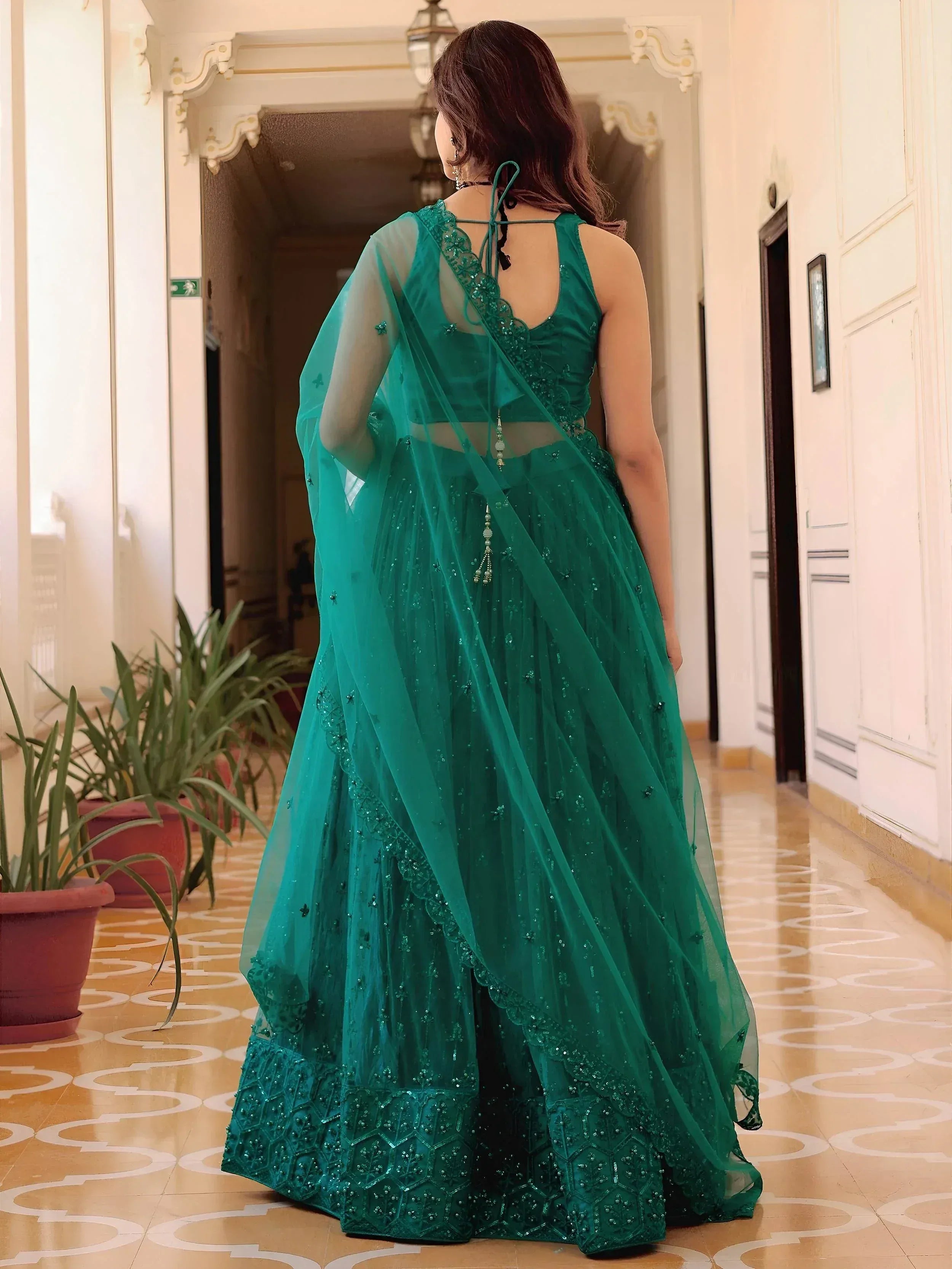 Emerald green designer lehenga choli with sheer dupatta, perfect for Indian weddings and festive occasions
