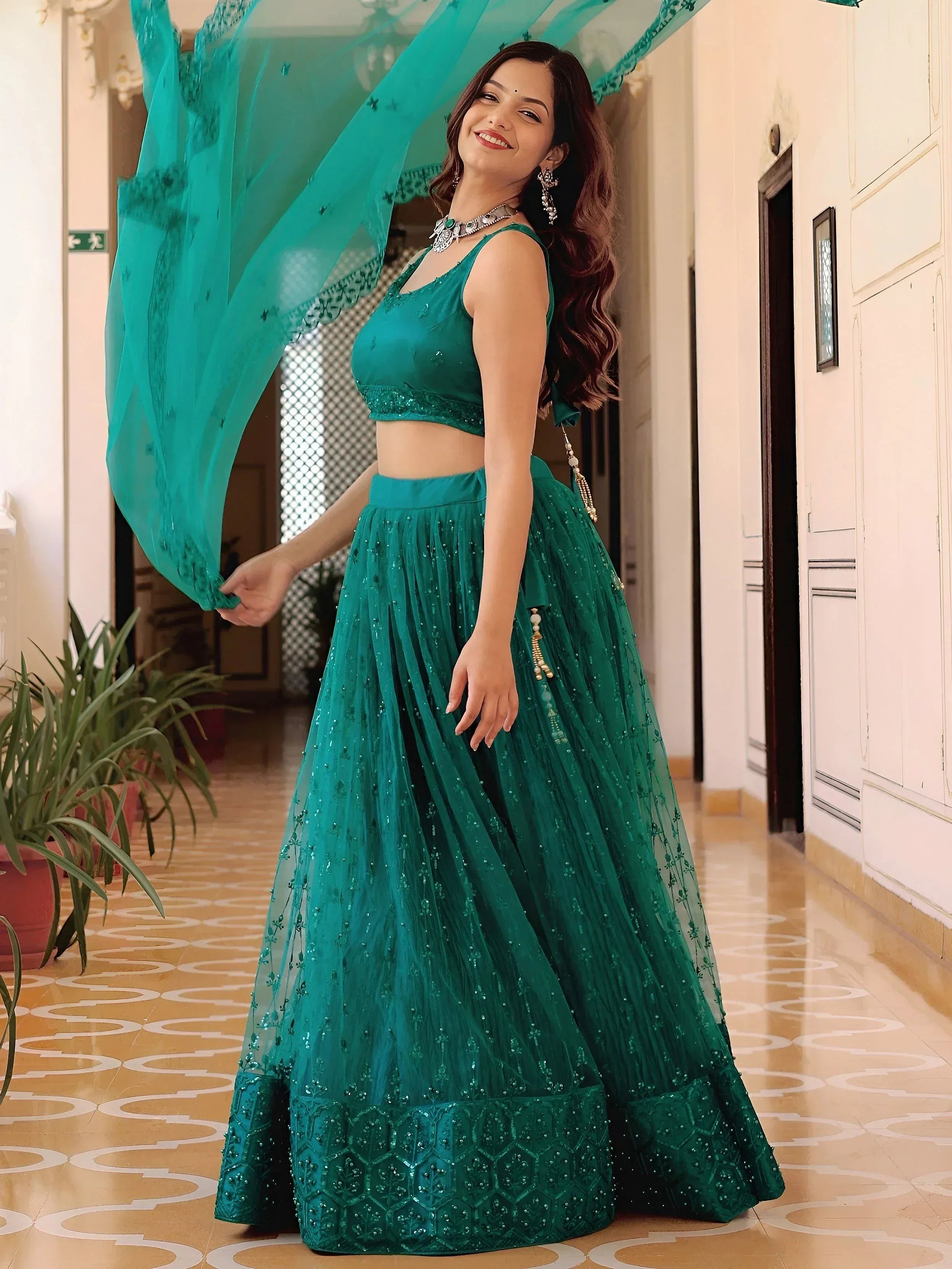 Emerald green designer lehenga choli with sequin work and flowing dupatta for Indian ethnic wear