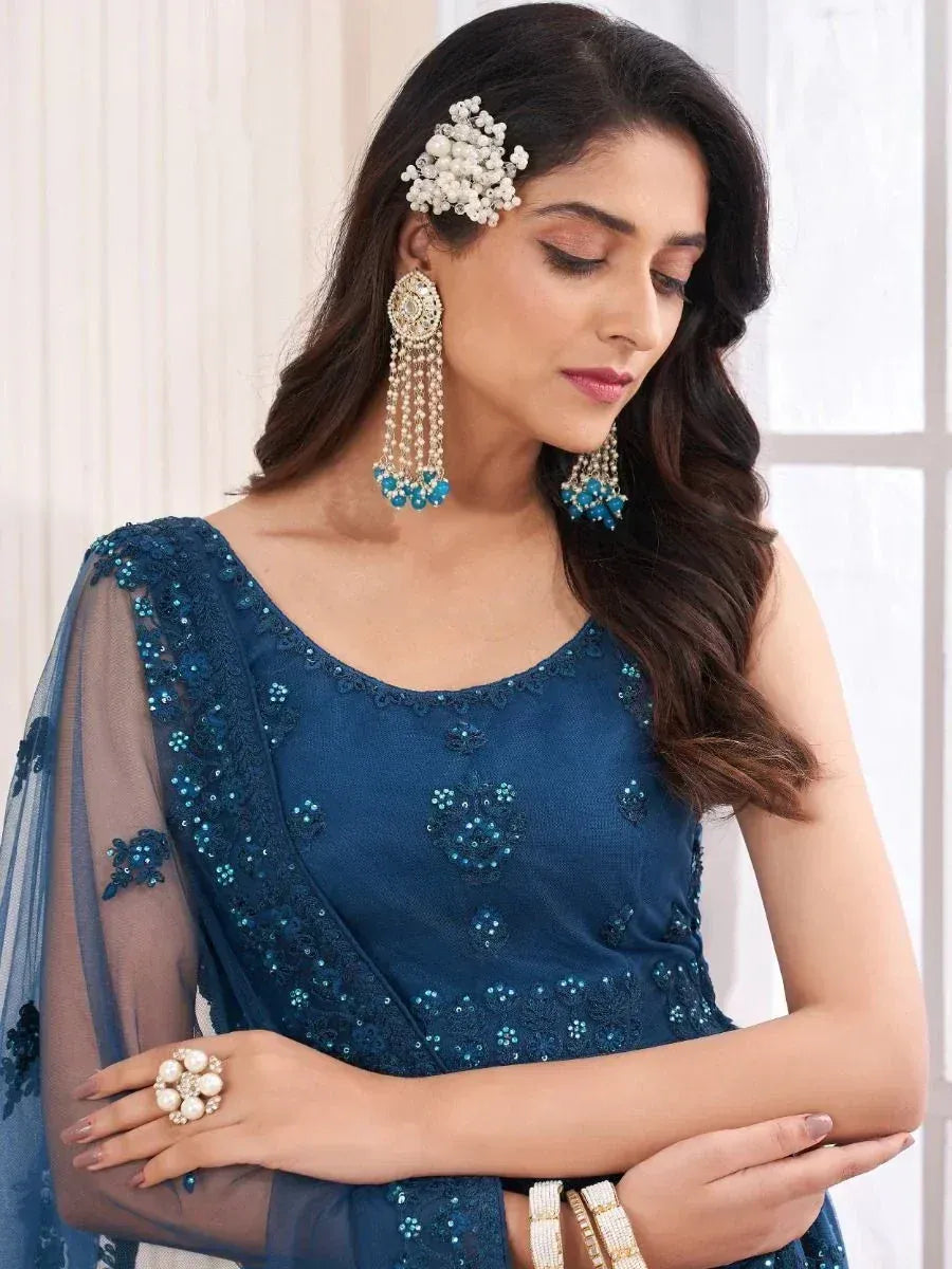 Elegant blue ethnic gown with sequin embroidery, matching jewelry, and sheer dupatta for Indian occasions