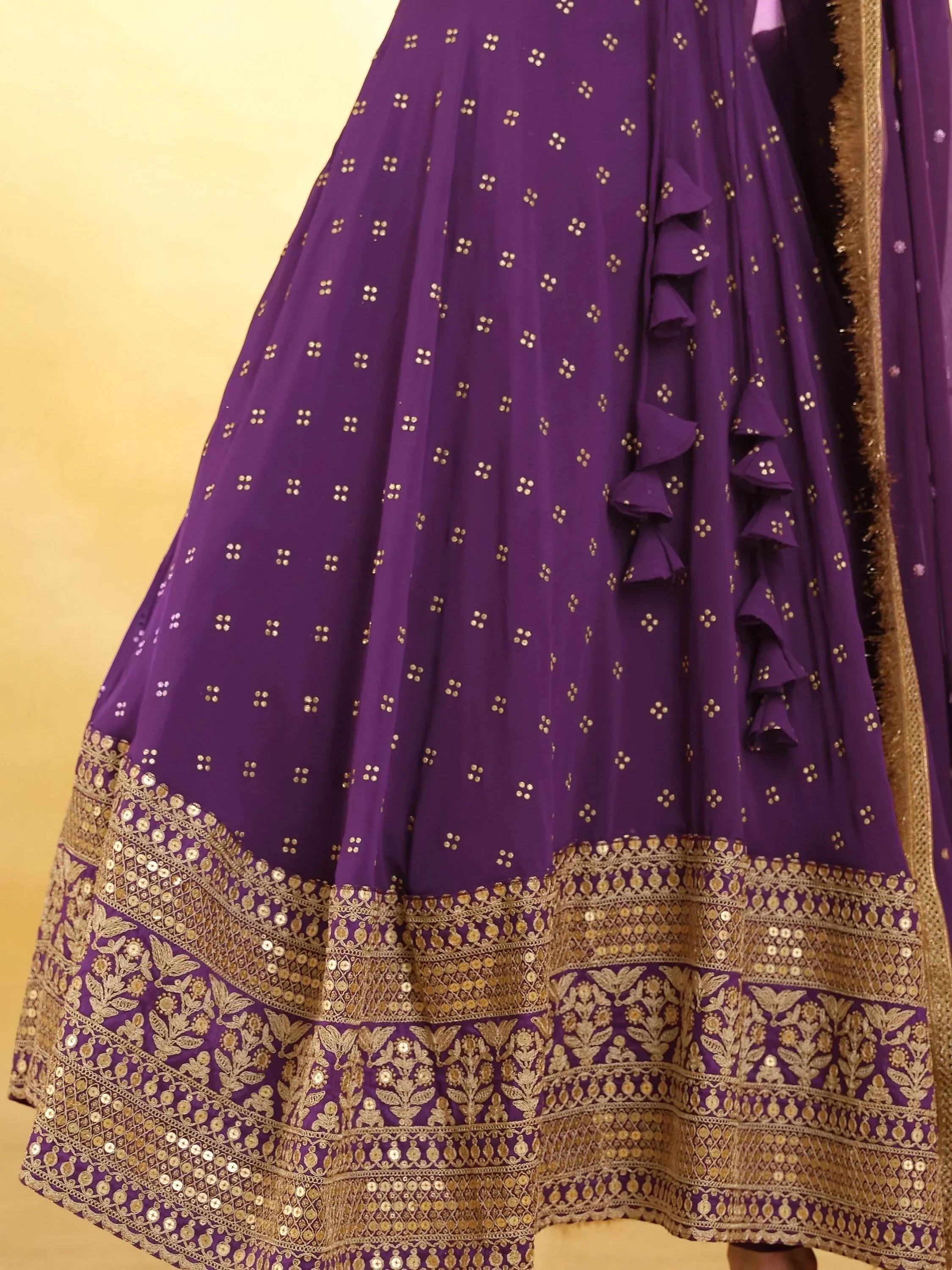 Purple lehenga with gold embroidered border and sequin floral patterns, ethnic Indian wear