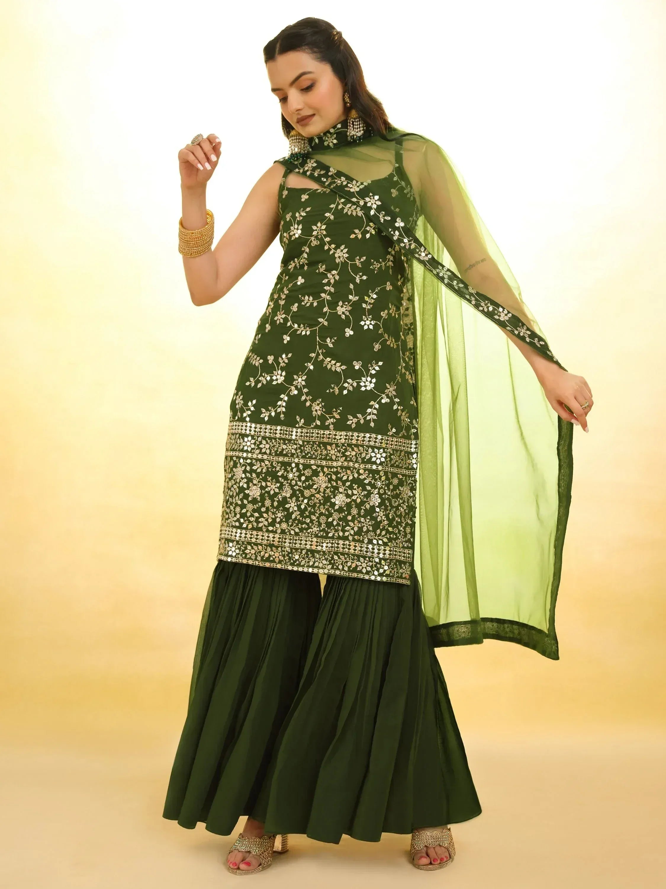 Emerald green embroidered ethnic gown with sheer dupatta, perfect for Indian weddings and festive occasions