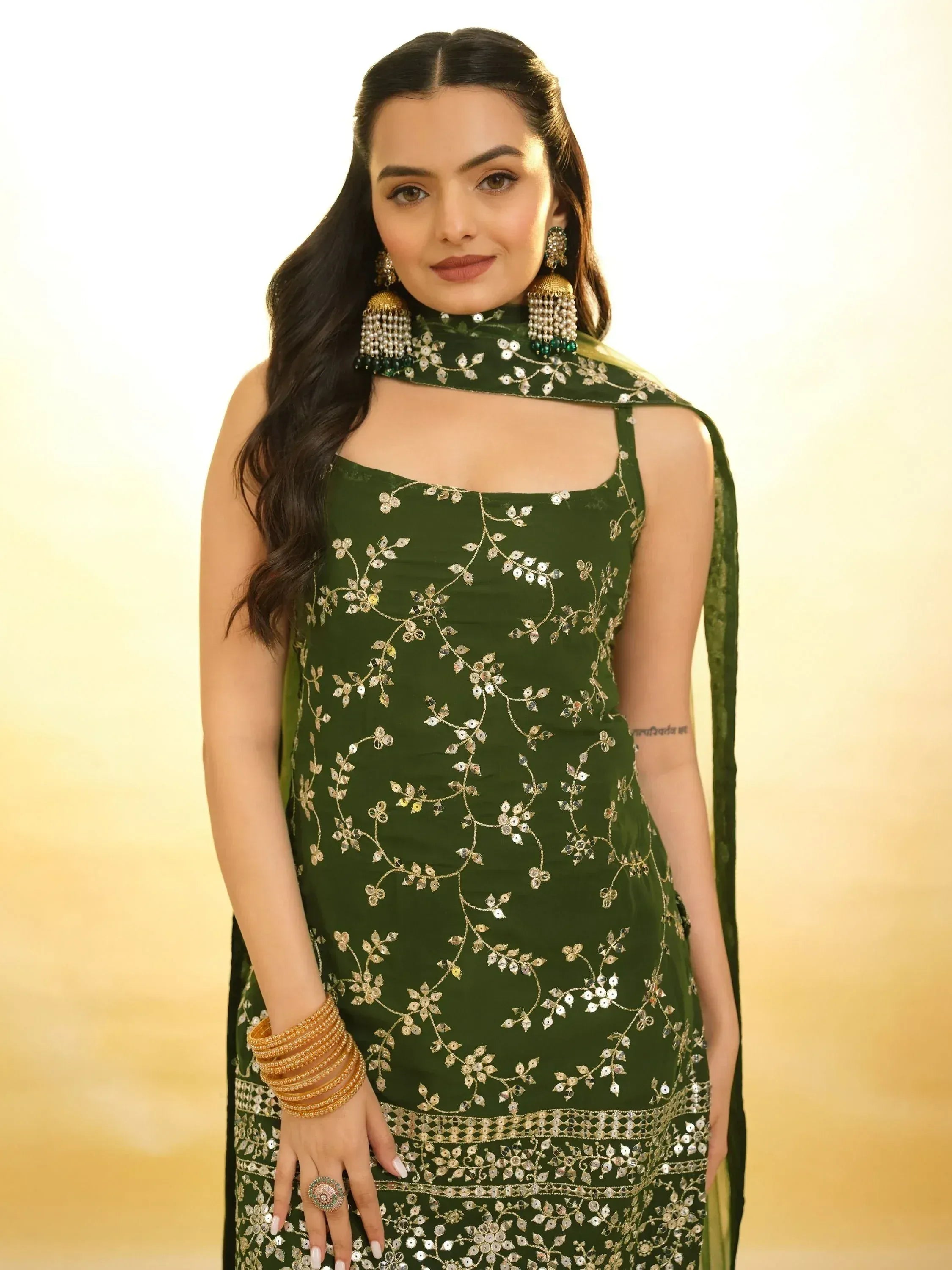 Green embroidered ethnic gown with gold detailing, perfect for Indian occasions and festive wear.
