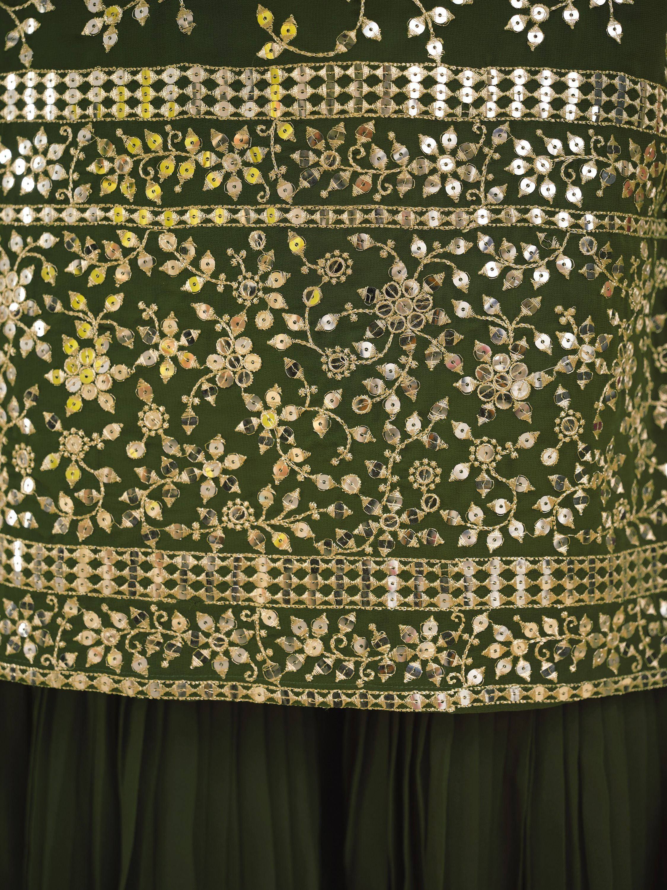Emerald green ethnic gown with intricate gold mirror and sequin embroidery, floral patterns, and border detailing.