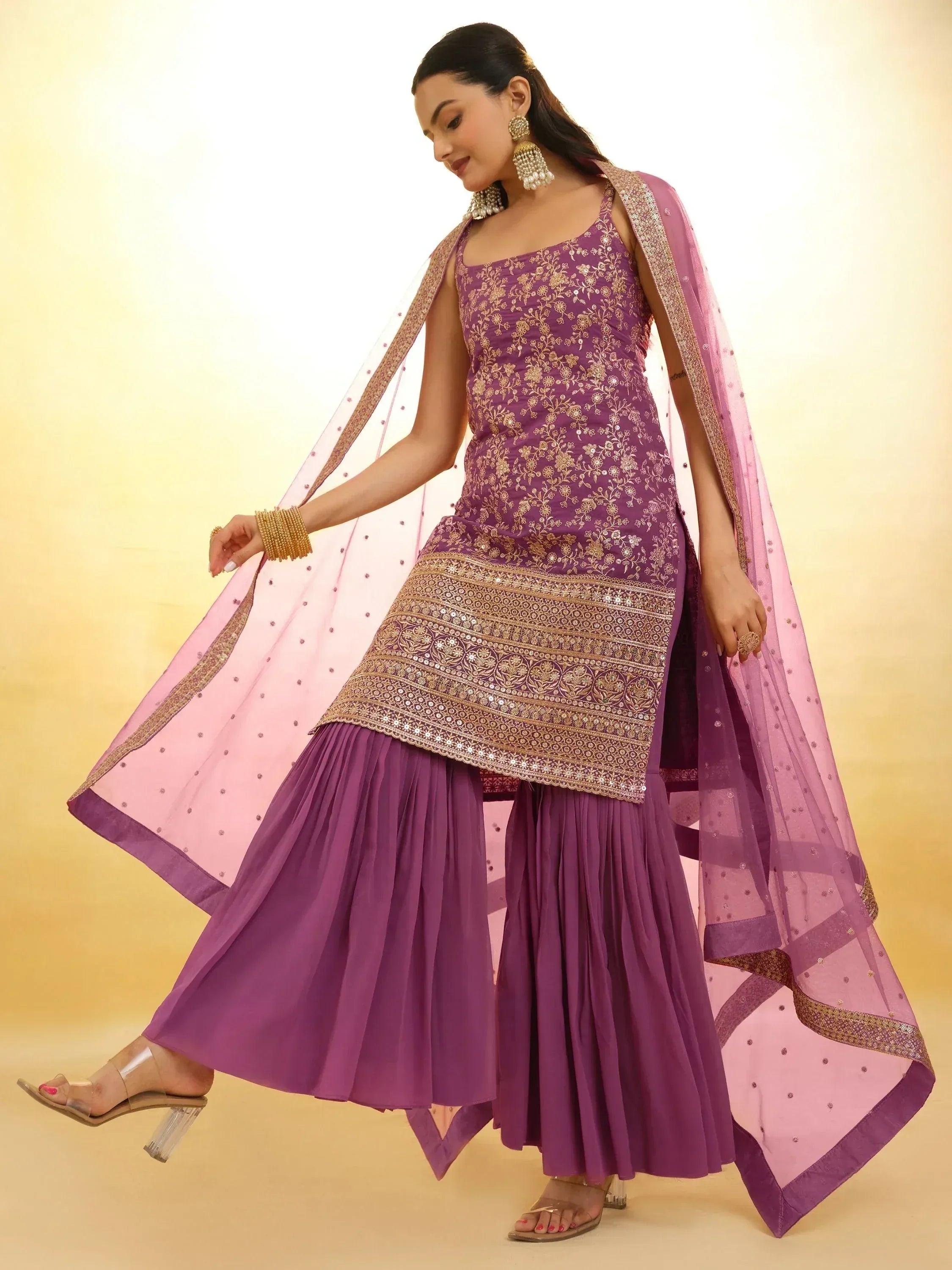 Purple embroidered ethnic gown with pleated skirt and pink dupatta, perfect for Indian occasions