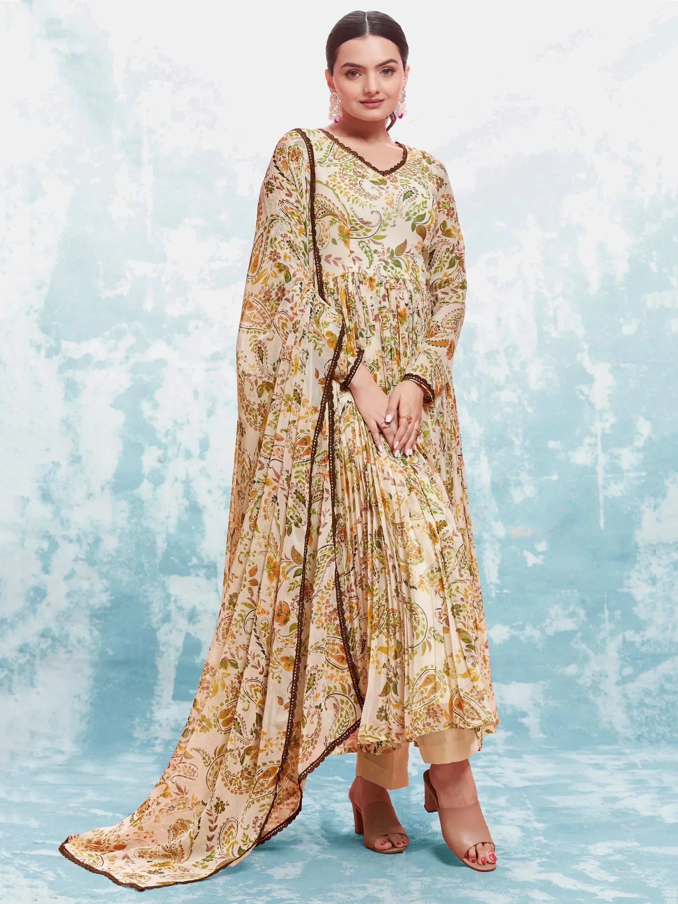 Woman wearing floral printed ethnic gown with matching dupatta and beige heels