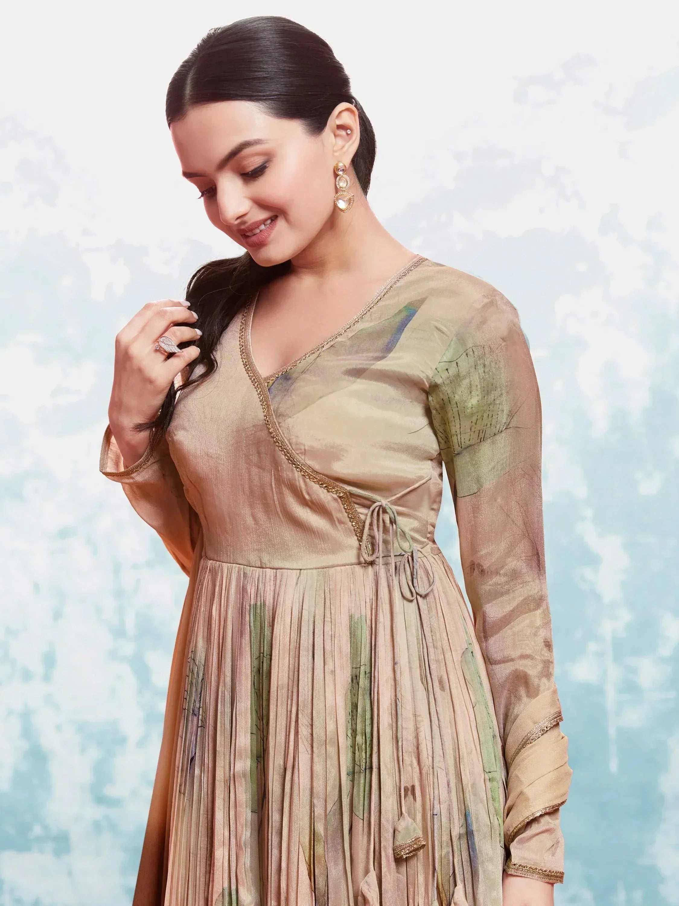 Elegant beige ethnic gown with green print, pleated skirt, and gold trim for women