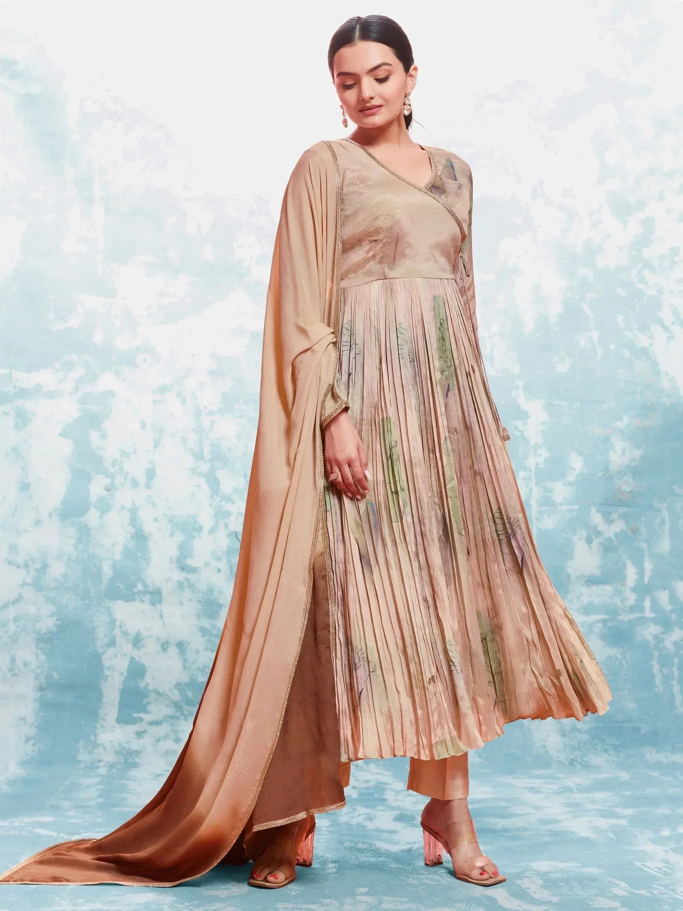 Beige pleated ethnic gown with floral print and matching dupatta, perfect for Indian occasions