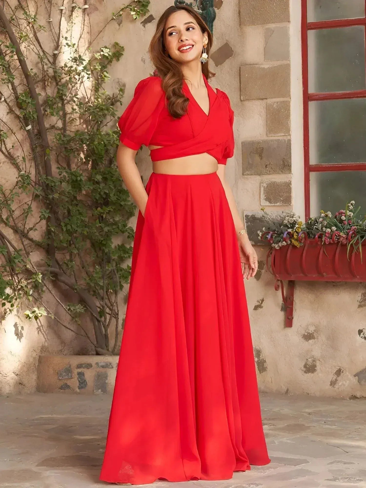 Vibrant red ethnic gown with puff sleeves and flared skirt, perfect for festive occasions