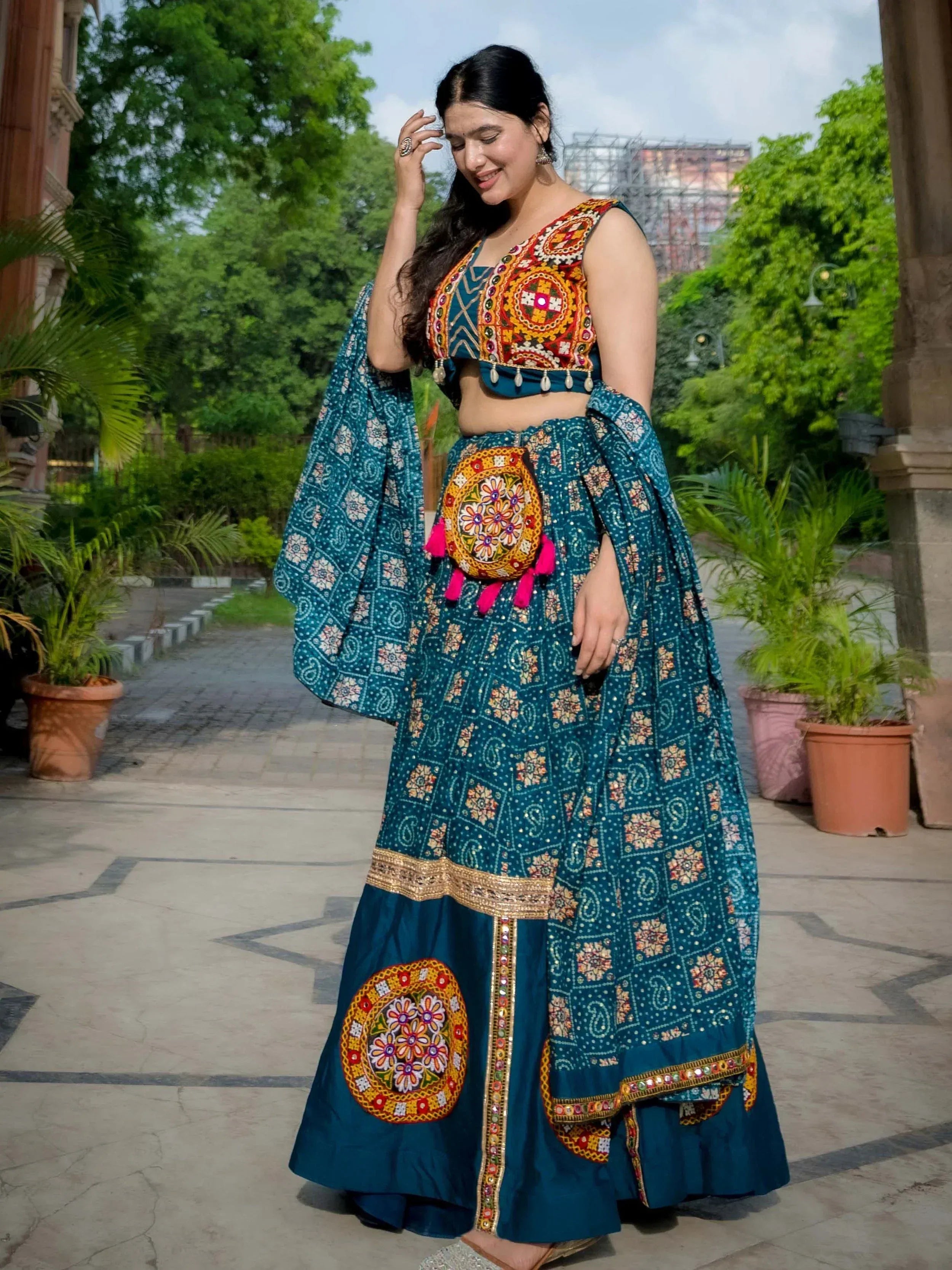 Teal embroidered lehenga choli with mirror work, floral motifs, and dupatta for Indian ethnic wear