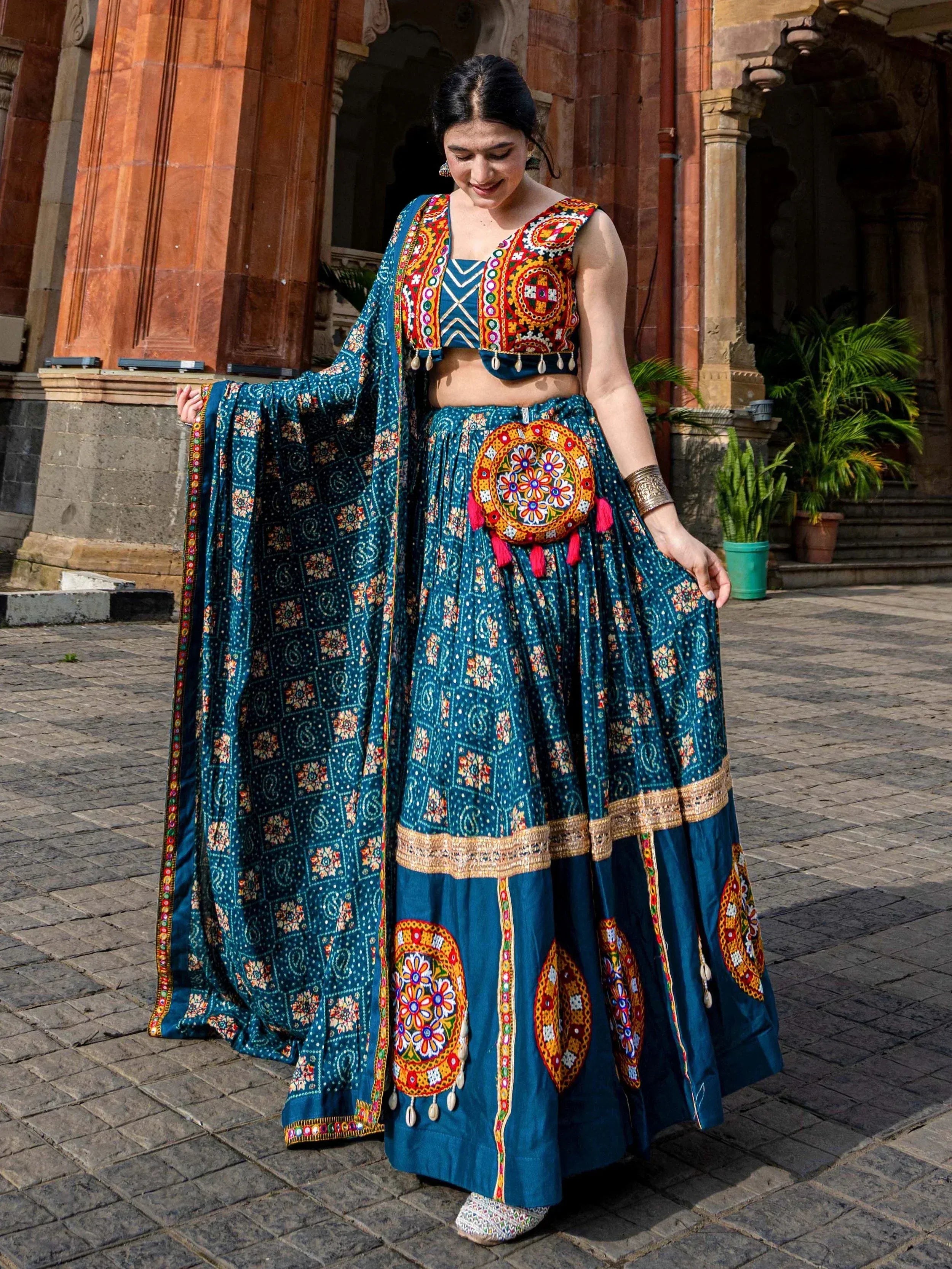 Teal embroidered lehenga choli with mirror work, perfect for Indian ethnic wear and festive occasions.