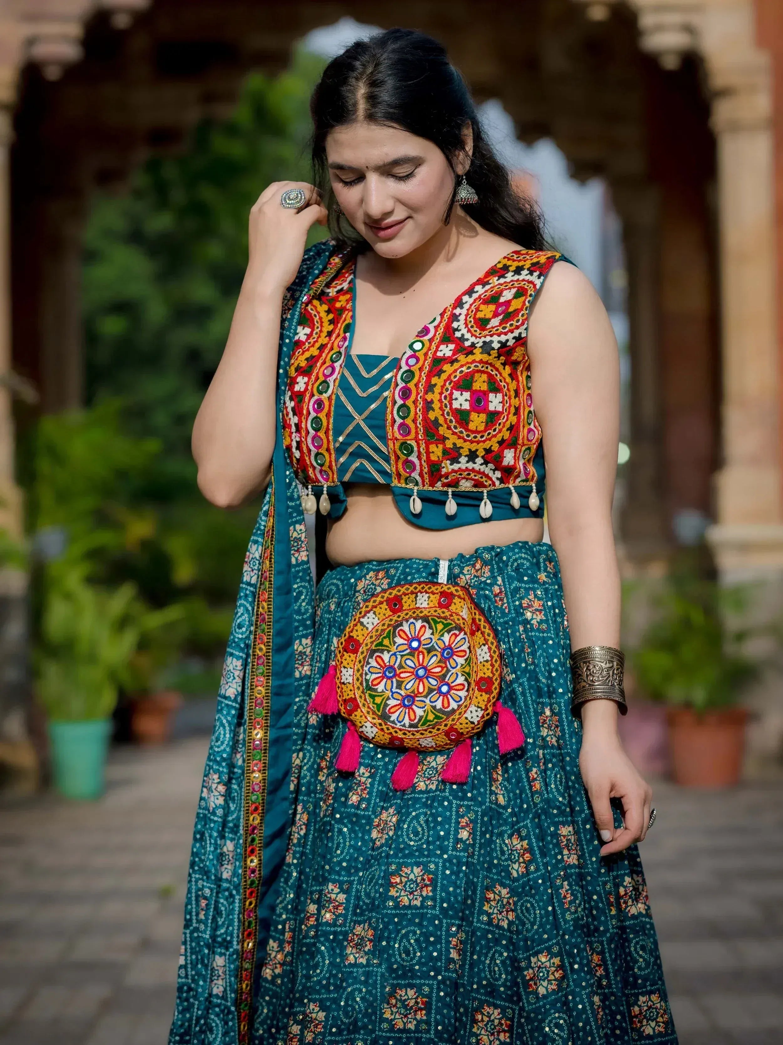 Teal embroidered lehenga choli with mirror work and floral motifs, perfect for Indian ethnic wear