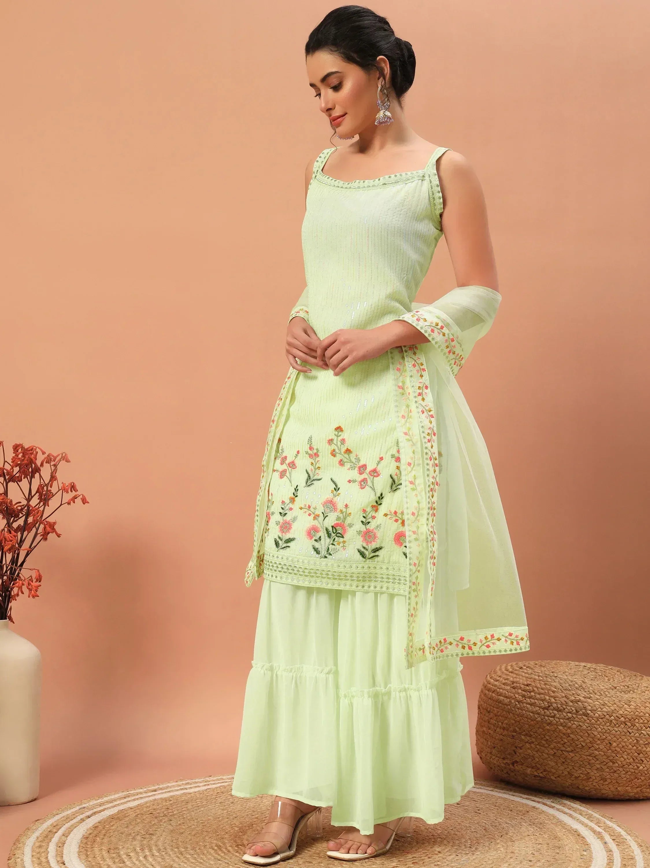 Light green embroidered ethnic gown with floral detailing, tiered skirt, and dupatta for women