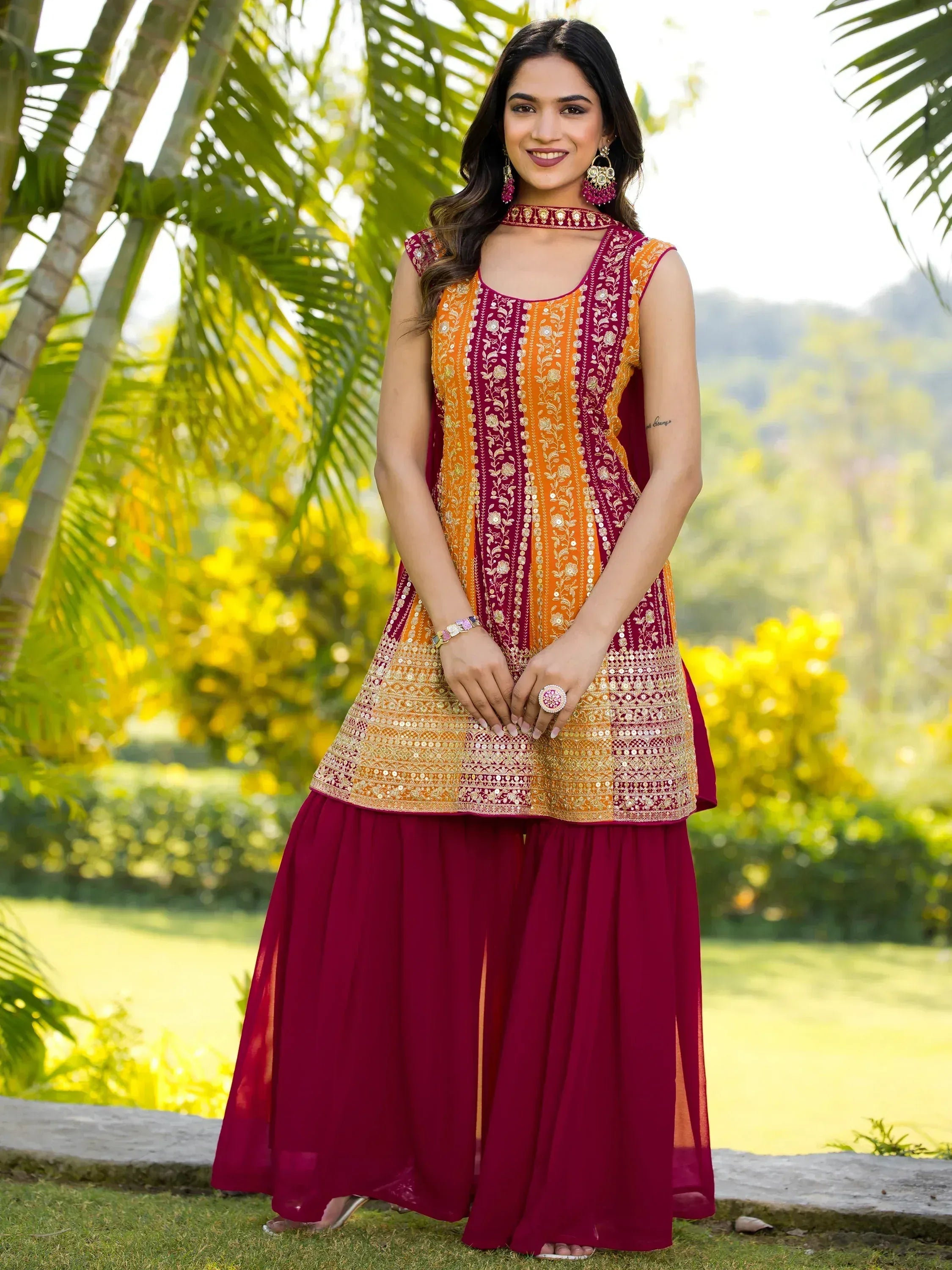 Woman in maroon and orange embroidered ethnic kurta with palazzo pants, perfect for Indian festive occasions.