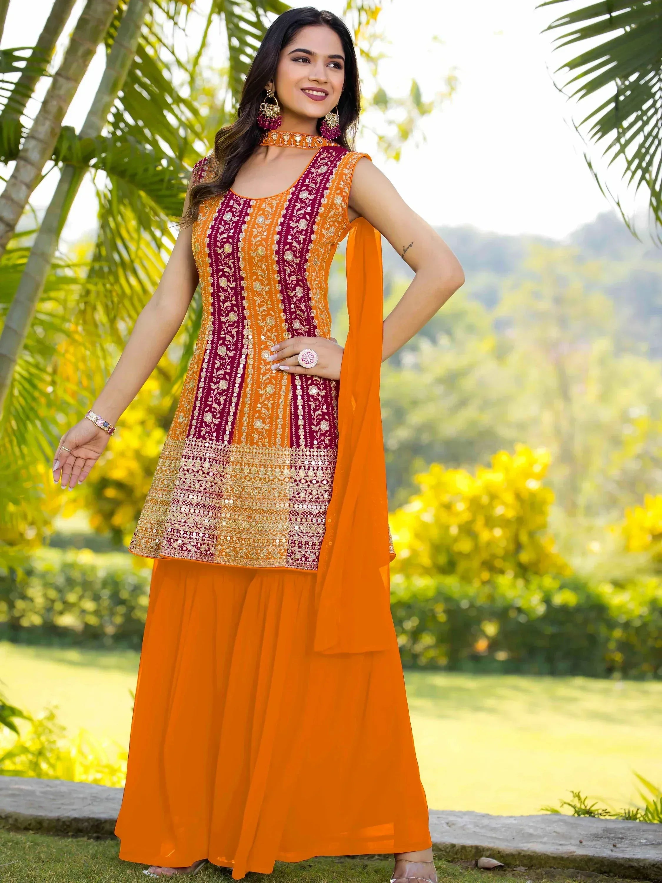 Orange and maroon embroidered salwar kameez with floral patterns, perfect for Indian ethnic wear occasions.