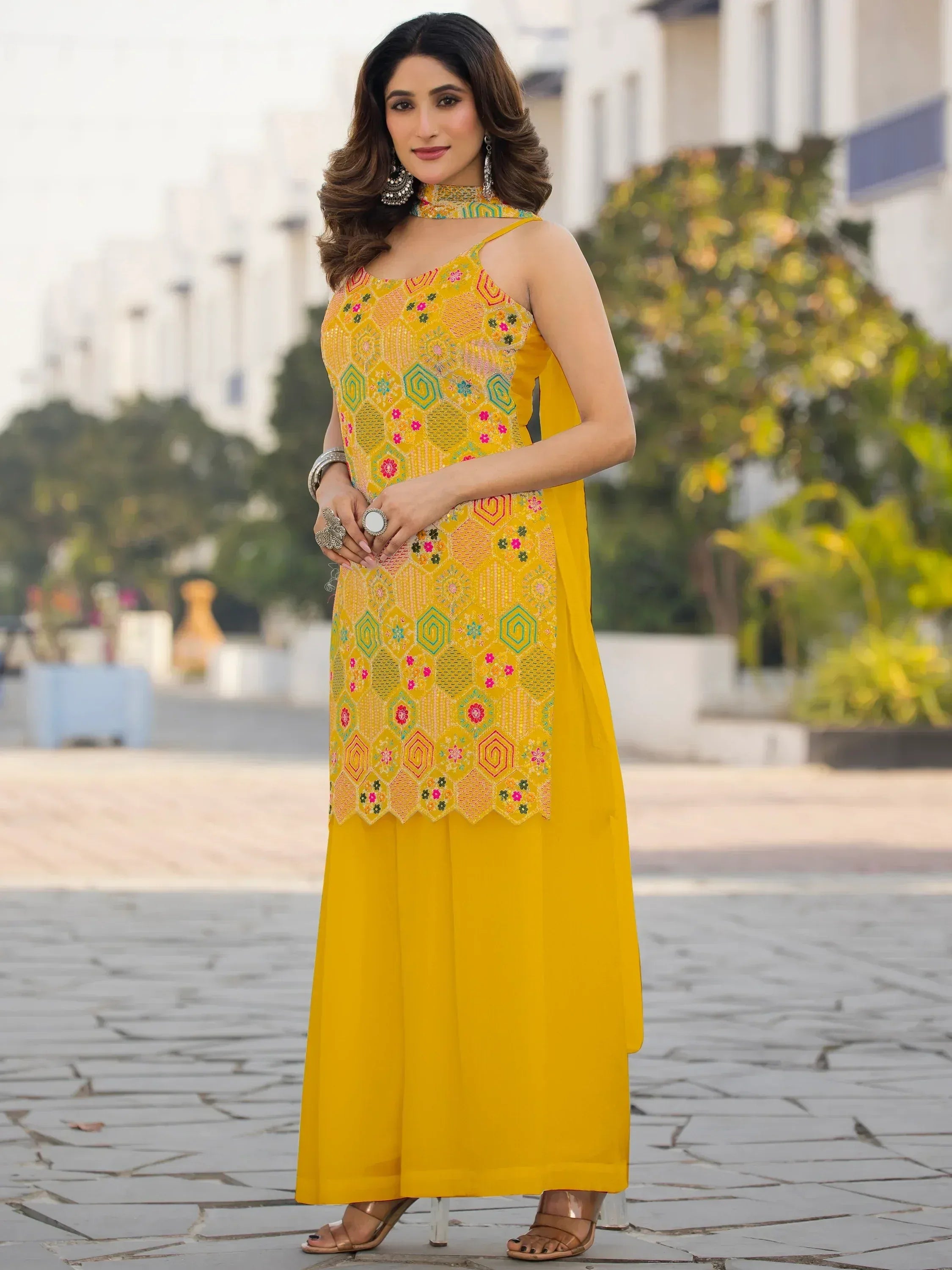 Yellow embroidered ethnic gown with floral patterns, perfect for Indian occasions and festive wear.
