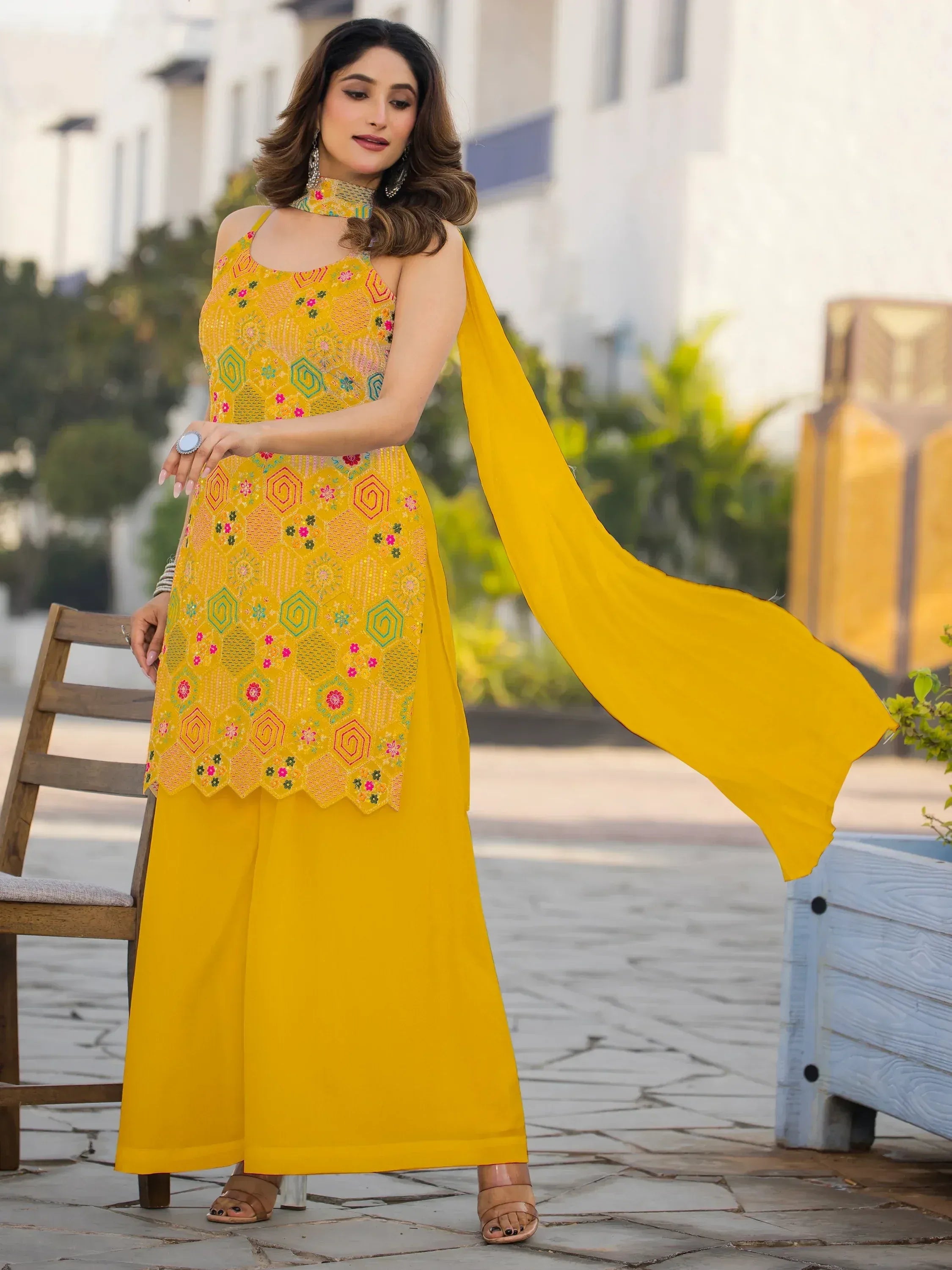 Yellow embroidered ethnic salwar kameez with floral patterns and matching dupatta, perfect for festive occasions.