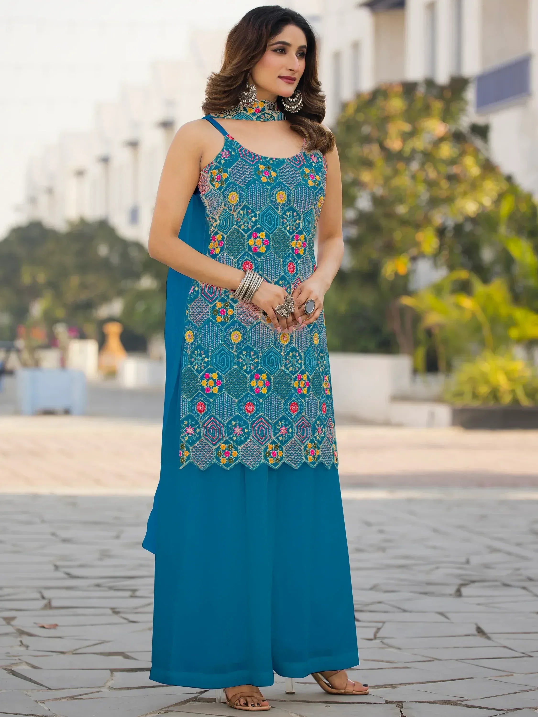 Teal embroidered ethnic gown with floral patterns, perfect for Indian festive wear and designer occasions.