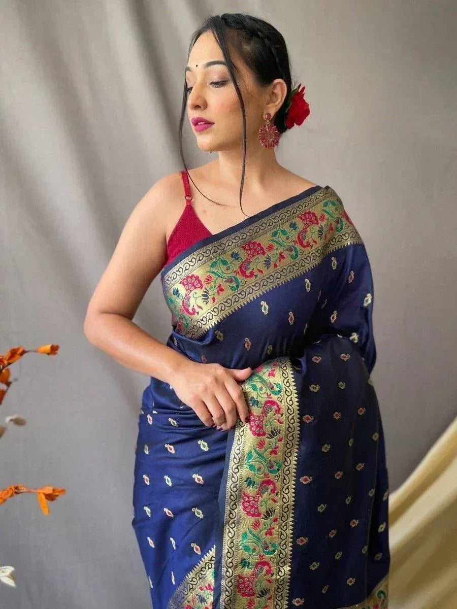 Navy blue embroidered saree with floral border, paired with red blouse, perfect for Indian ethnic occasions