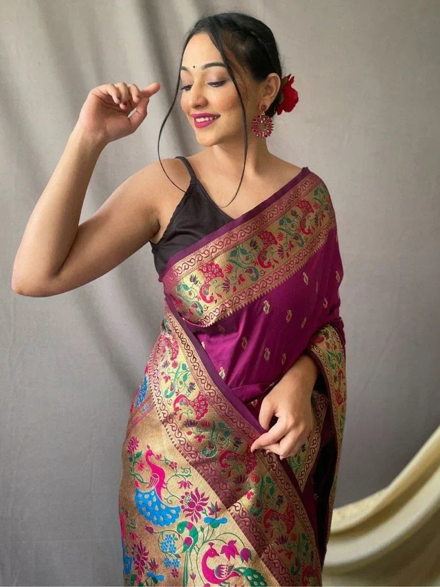 Woman in purple designer saree with peacock embroidery, ethnic Indian wear