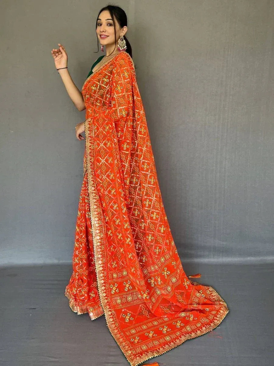 Orange embroidered saree with gold patterns, paired with green blouse, Indian ethnic wear