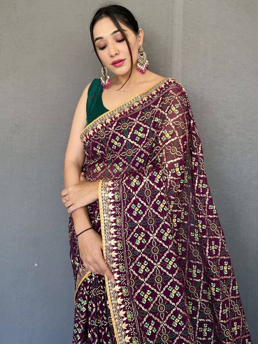 Elegant maroon printed saree with gold border and green blouse, perfect for Indian ethnic occasions