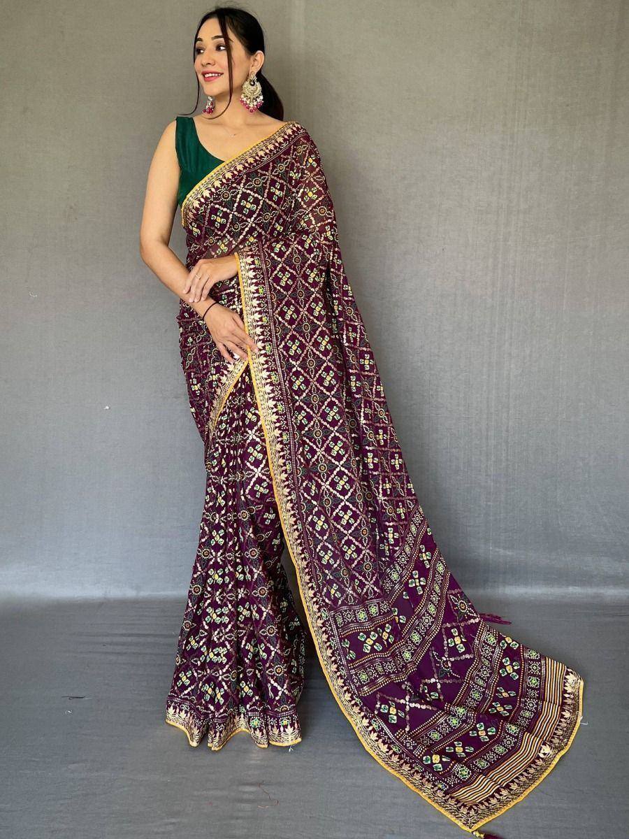 Purple printed saree with gold border, paired with green blouse, ethnic Indian wear