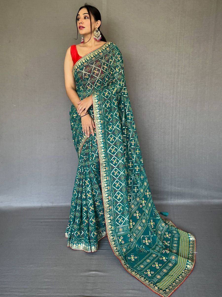 Teal printed saree with gold embroidery, paired with red blouse, ethnic Indian wear