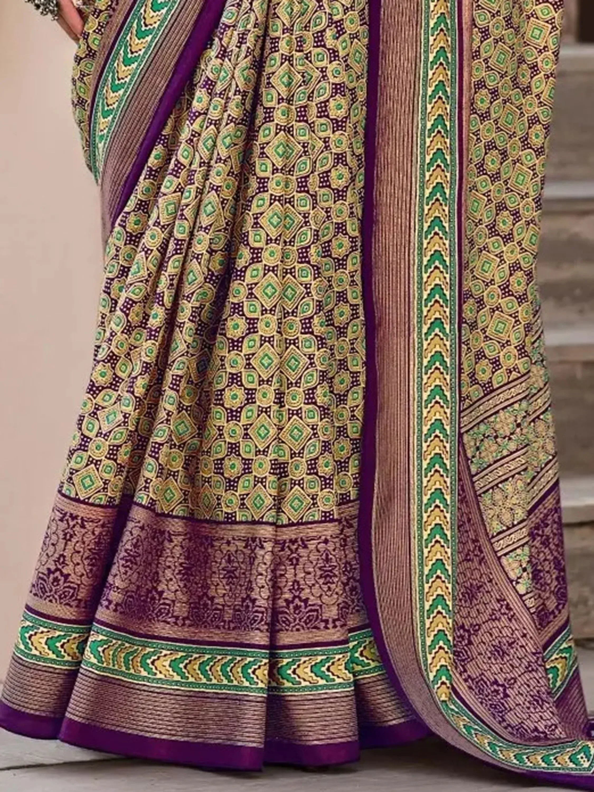 Purple and green printed saree with intricate geometric patterns and woven border, ideal for ethnic occasions