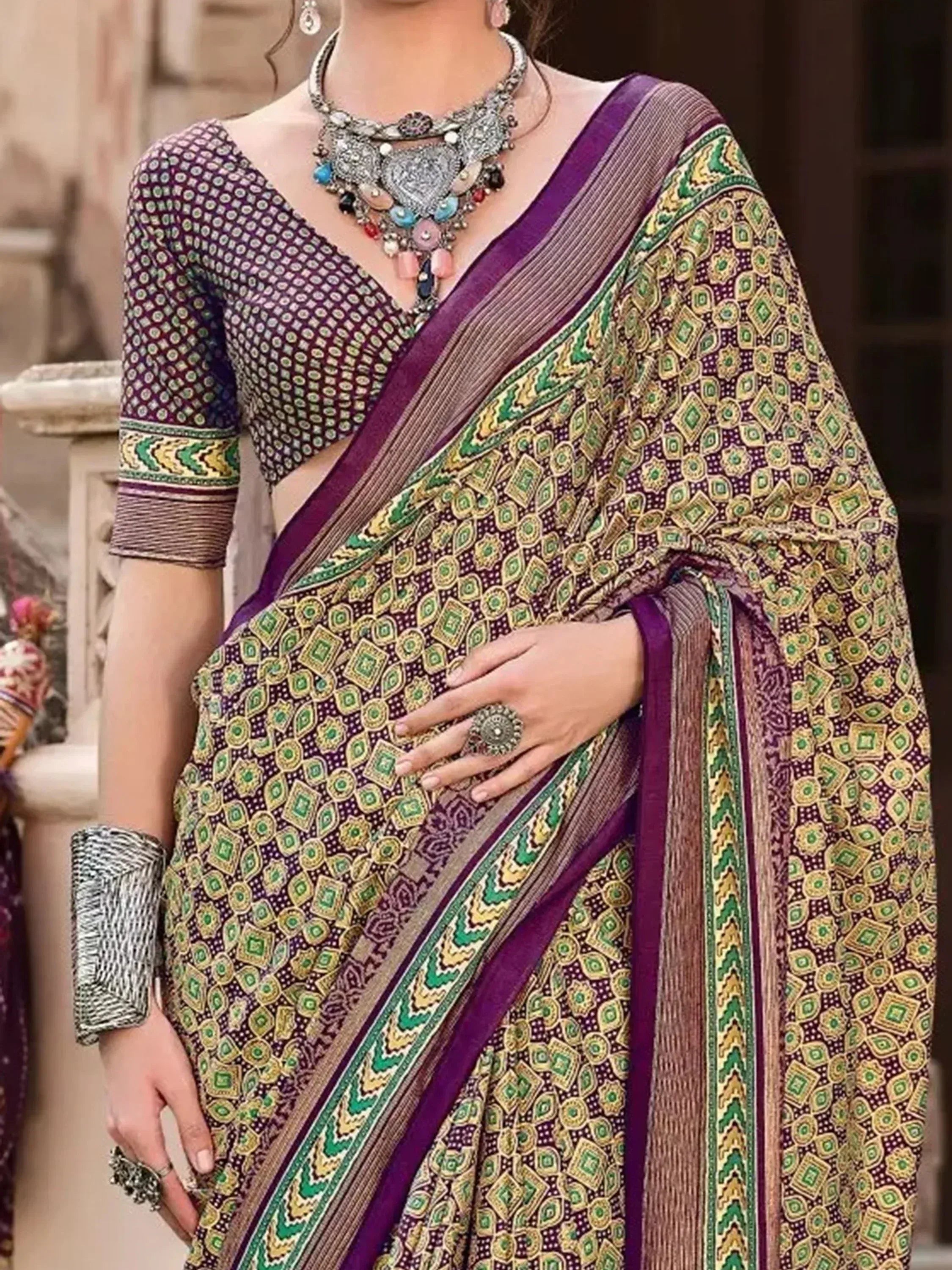 Purple and green printed saree with matching blouse, ethnic jewelry, and traditional Indian design