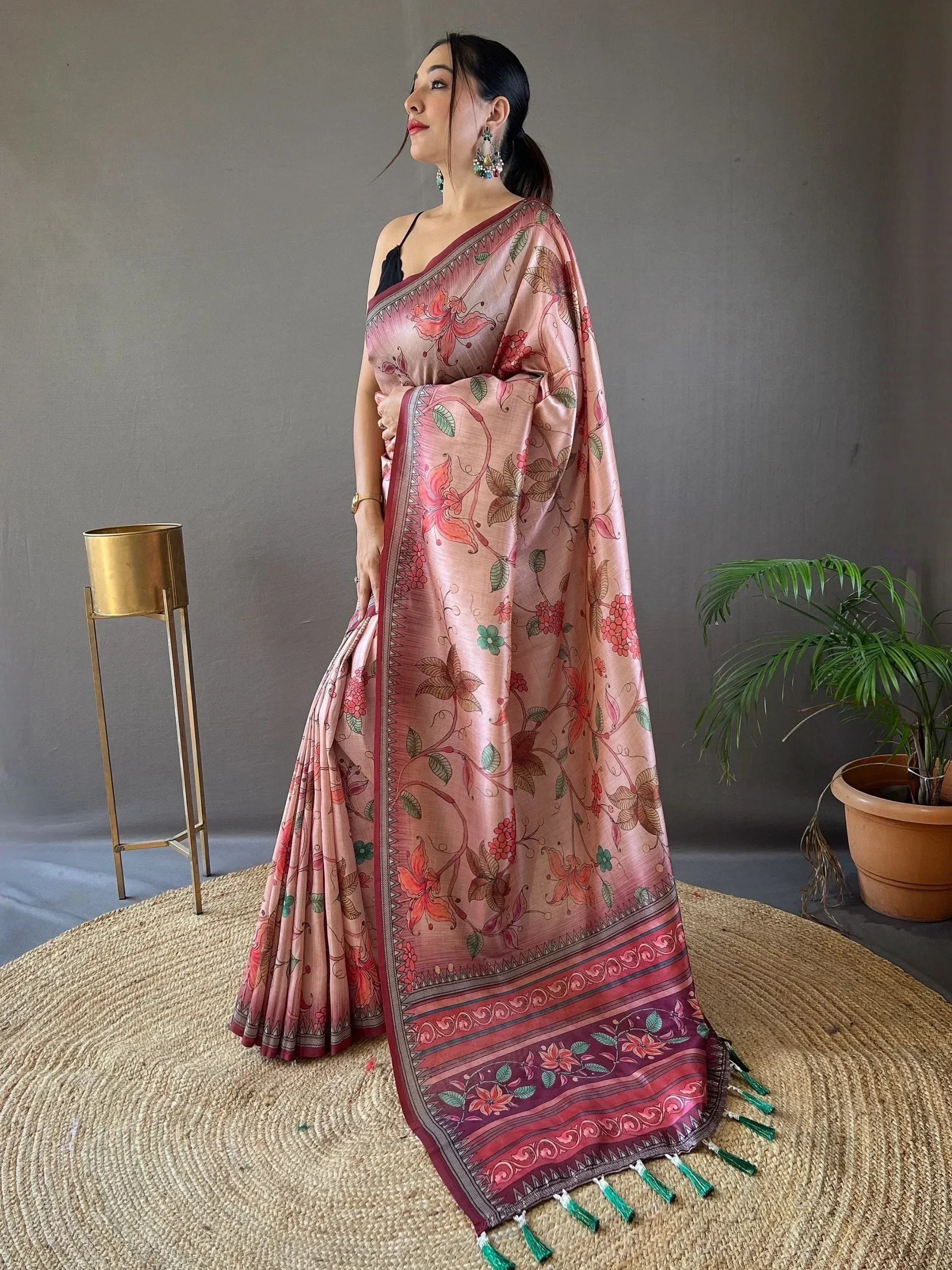 Woman in elegant pink floral saree with green tassels, Indian ethnic wear for festive occasions
