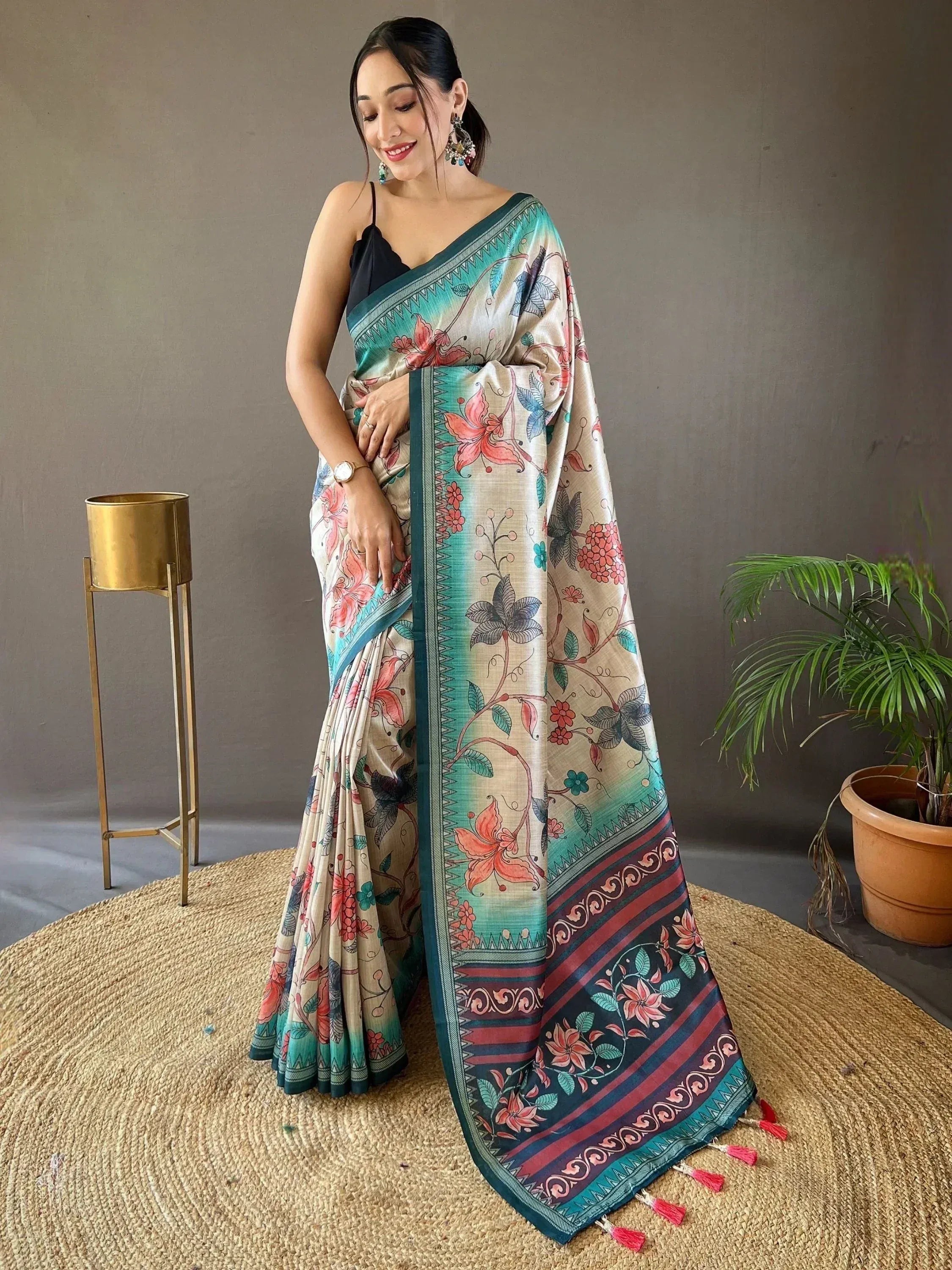 Woman in floral printed saree with teal border, ethnic wear for Indian occasions