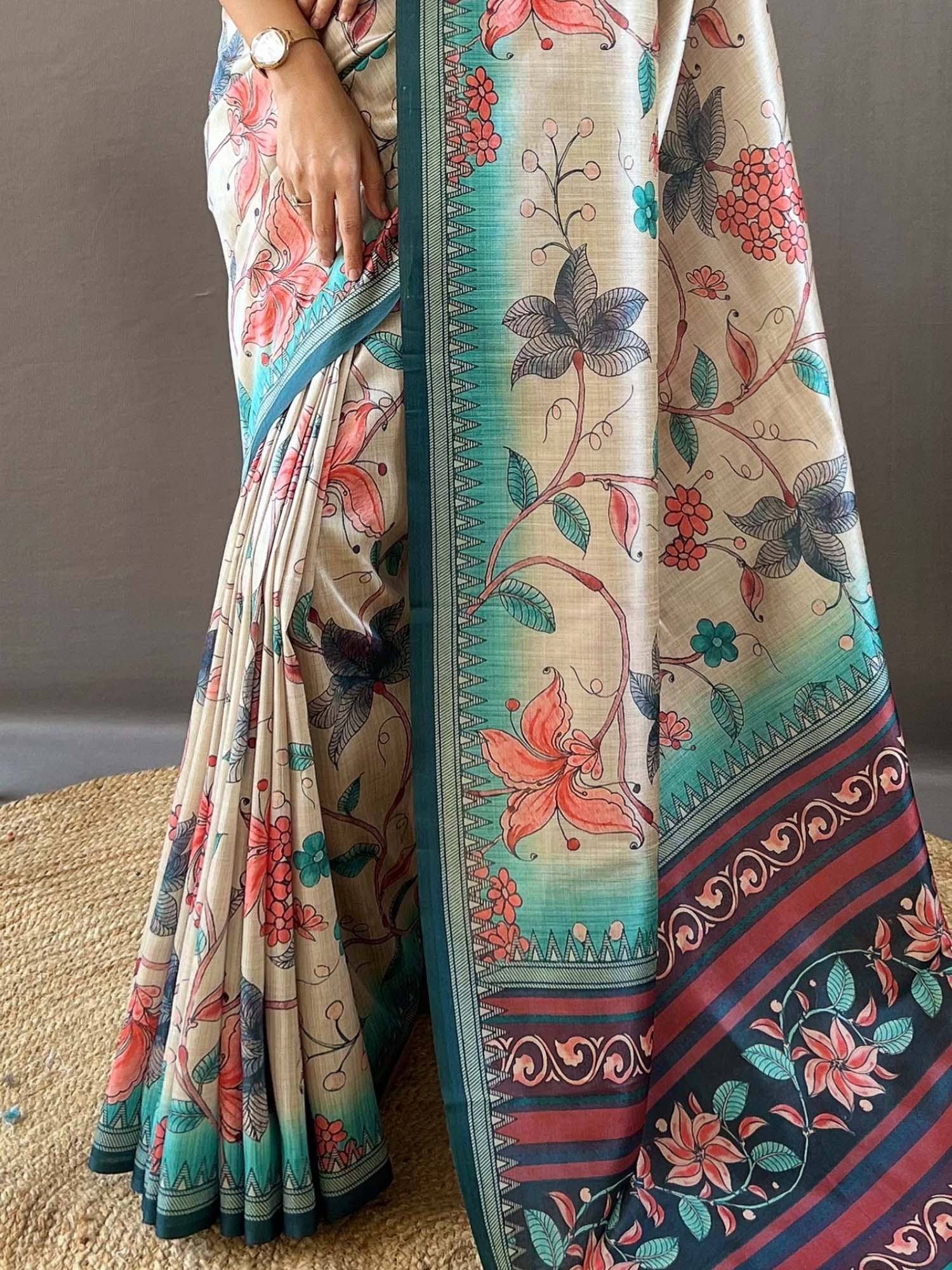 Floral print ethnic saree with teal border, perfect for Indian occasions and festive wear.