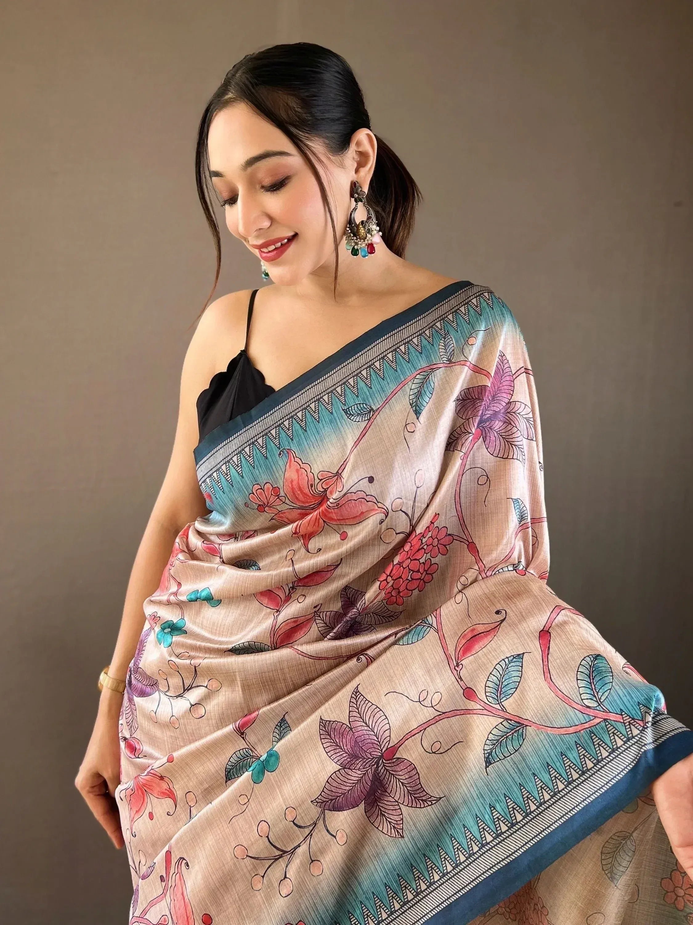 Woman in floral print saree with blue border, ethnic Indian wear
