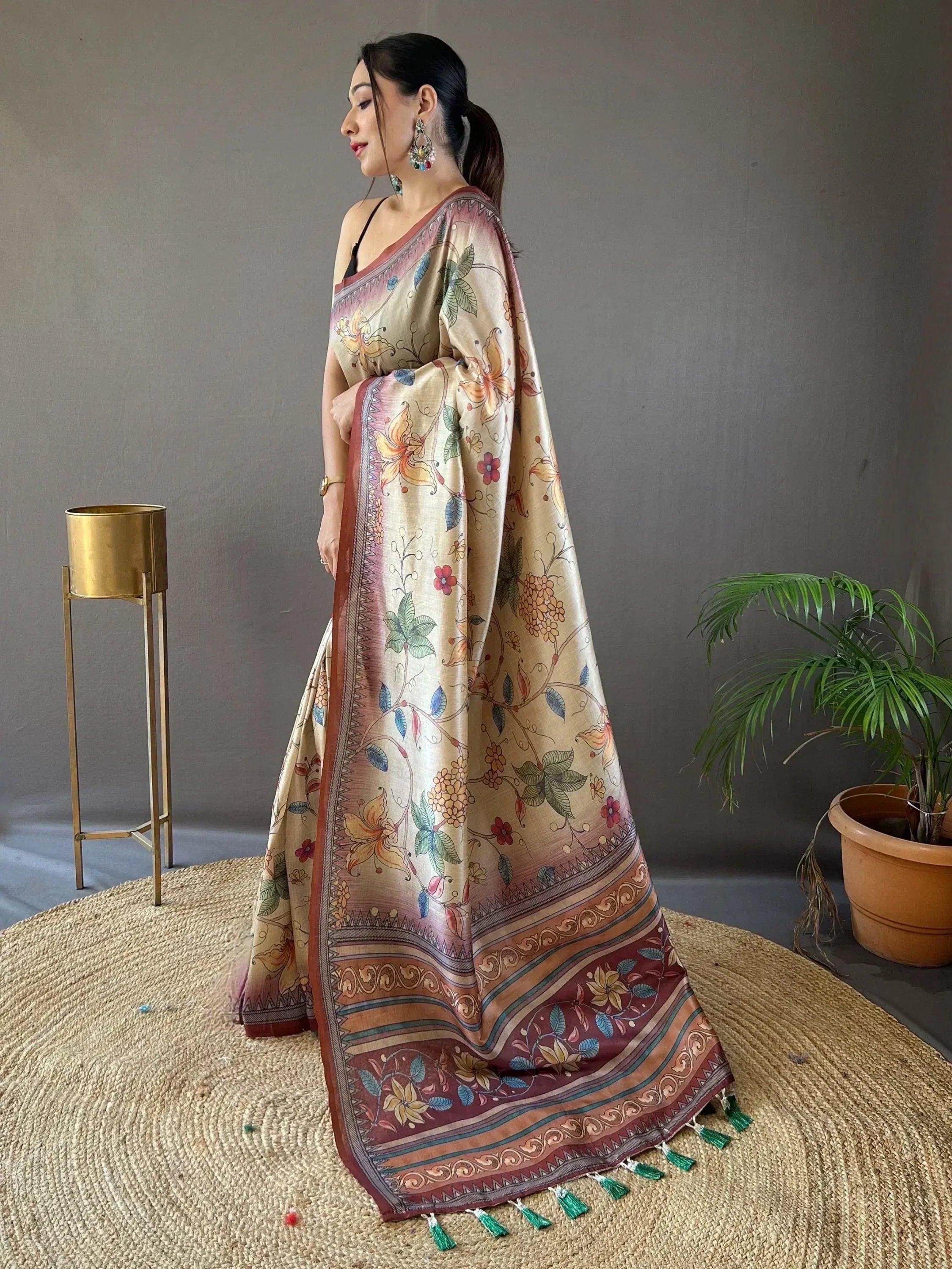 Woman wearing floral printed ethnic saree with tassels, perfect for Indian occasions and festive wear.
