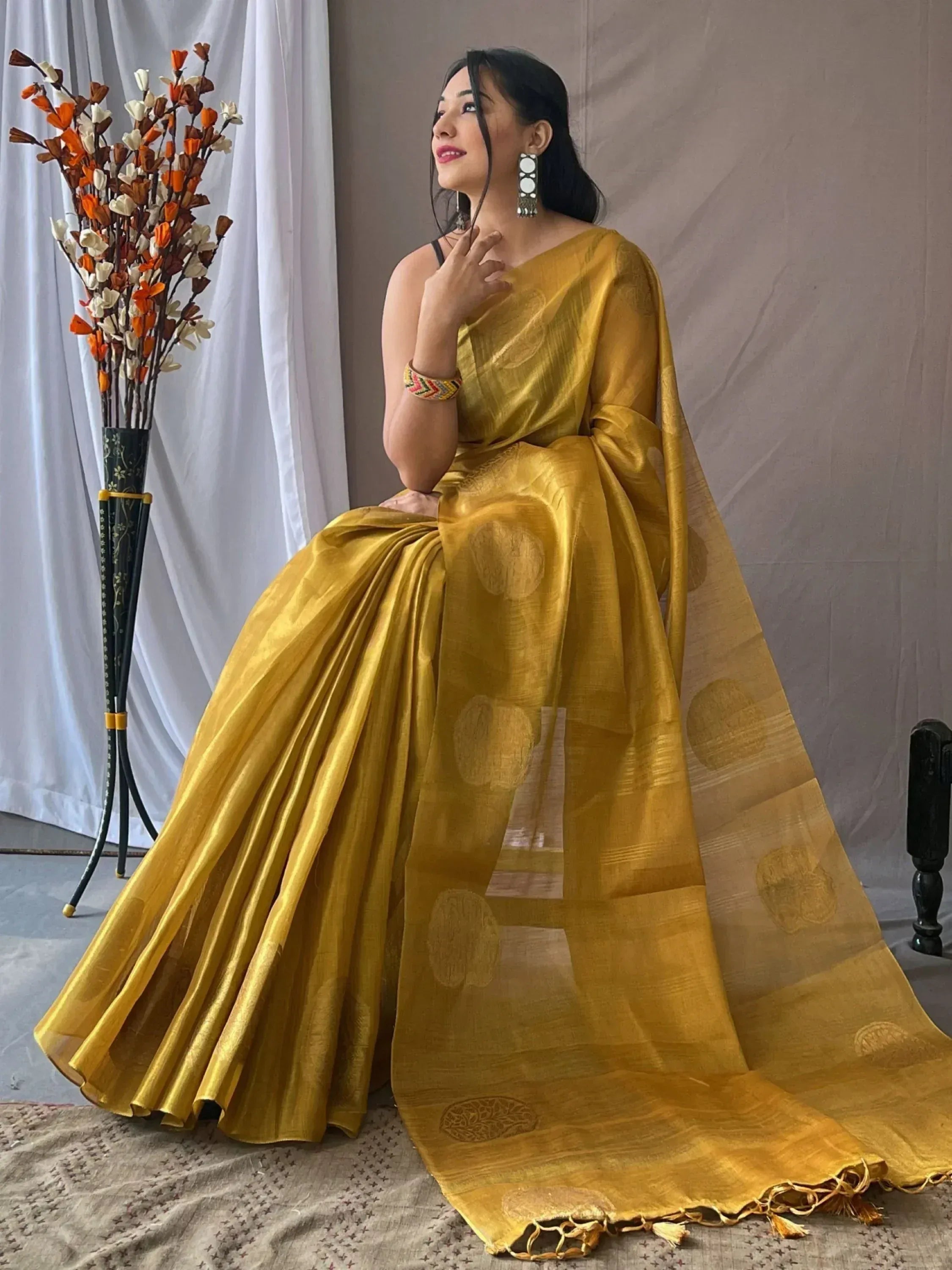 Golden ethnic saree with woven motifs, perfect for Indian occasions and festive wear