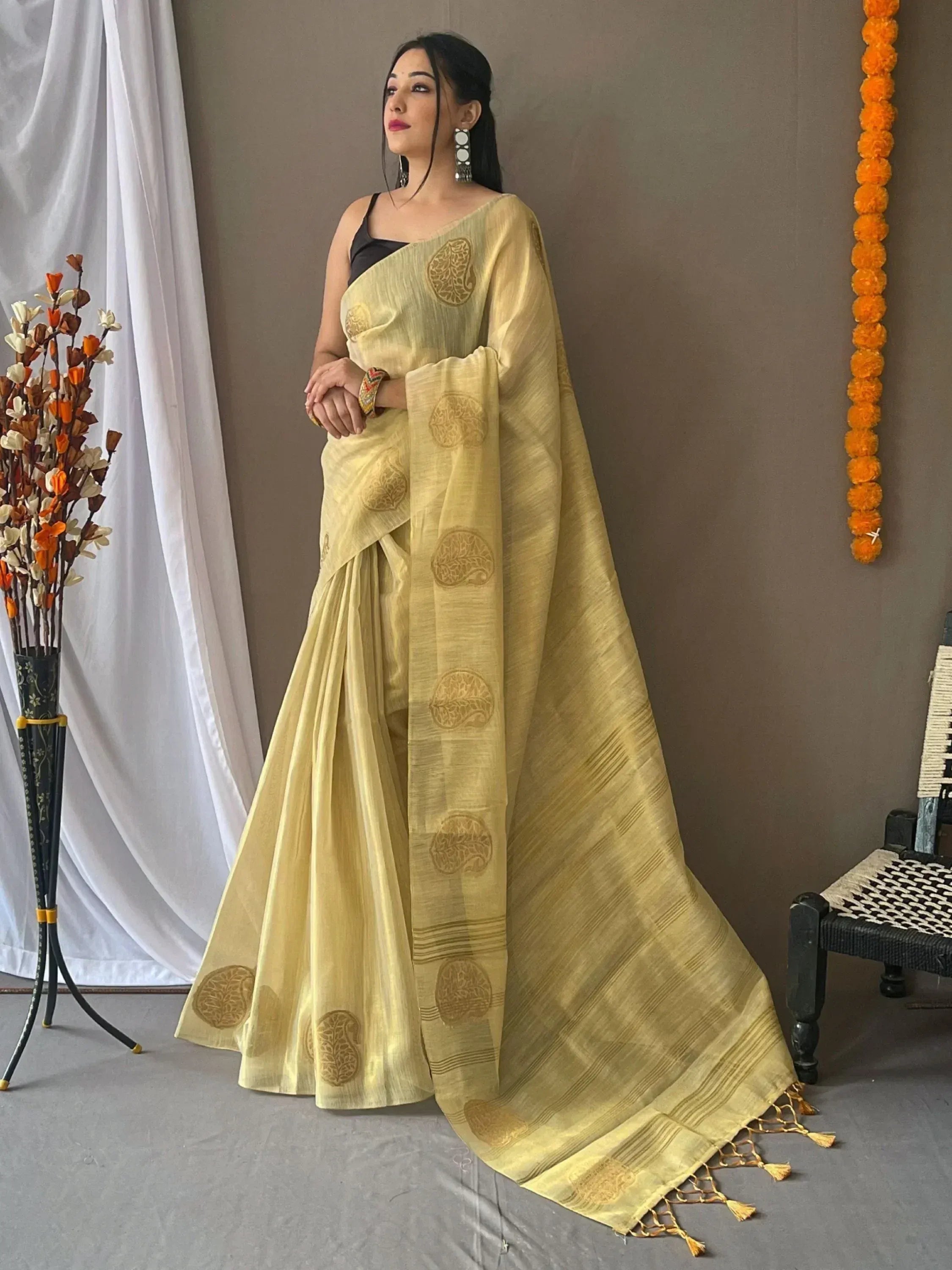 Yellow ethnic saree with gold paisley print, perfect for Indian occasions and festive wear.