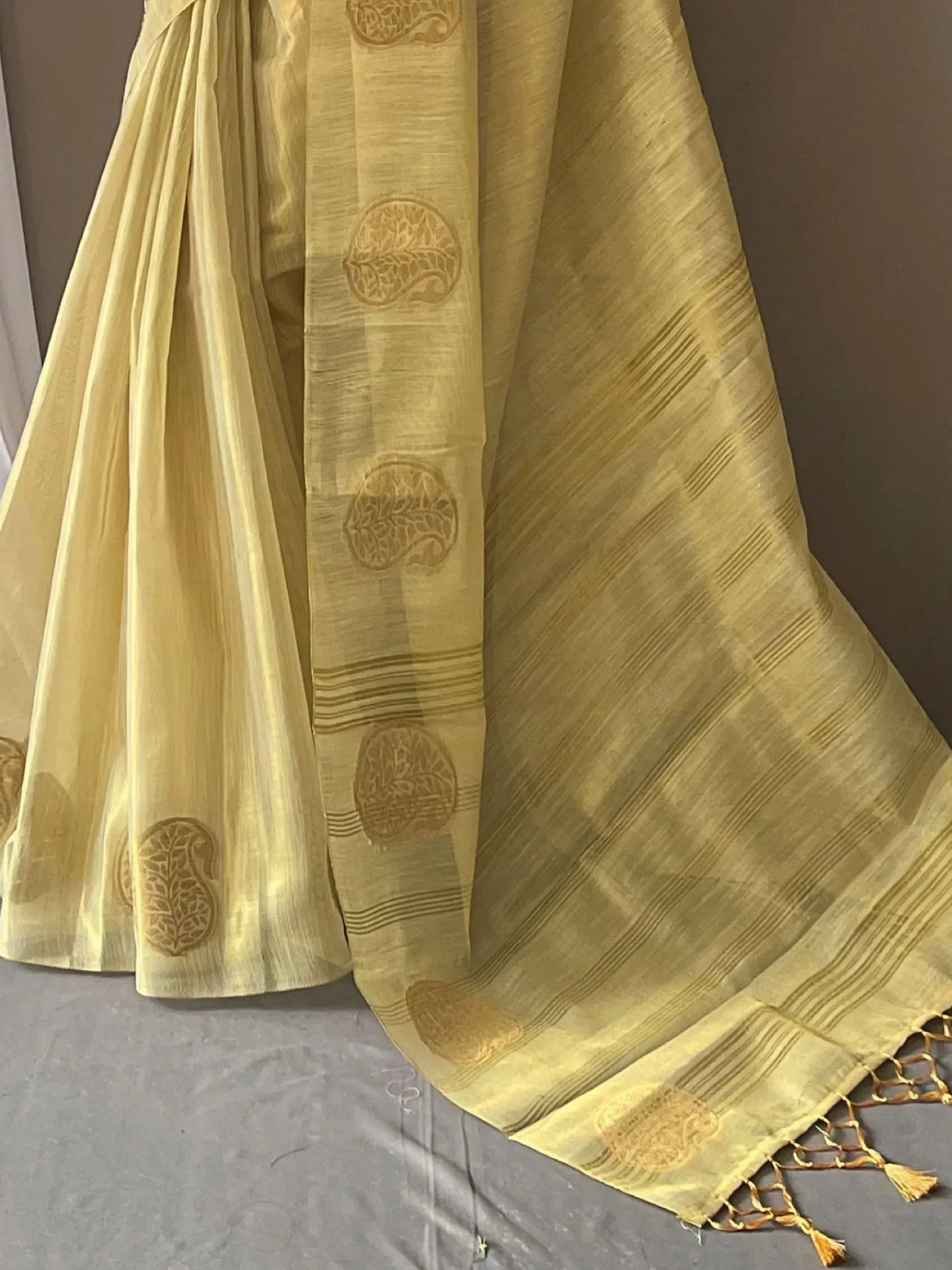Yellow ethnic saree with paisley print and tassels, ideal for Indian occasions
