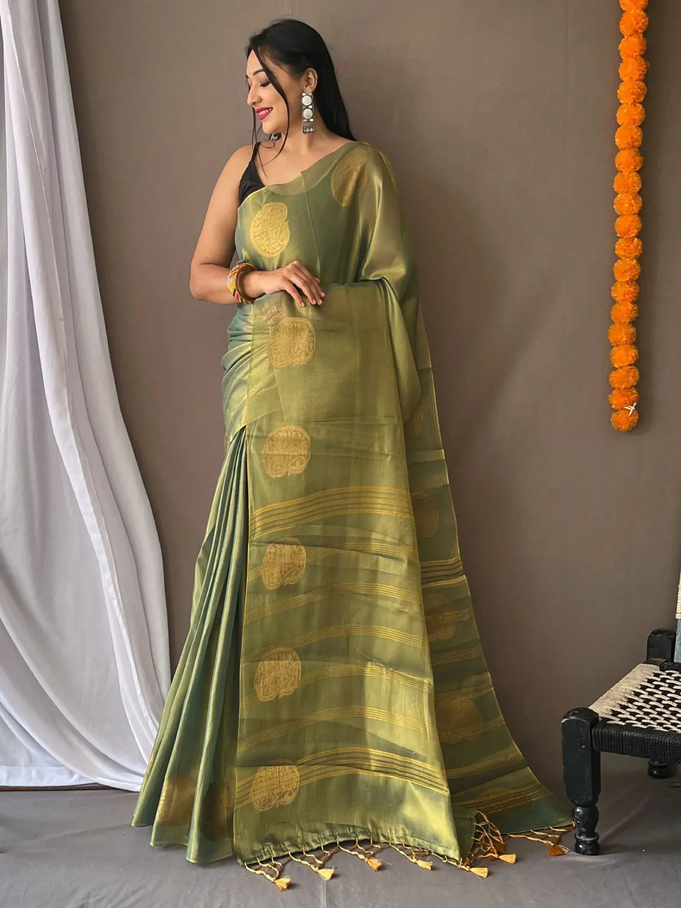Olive green saree with gold circular motifs and stripes, paired with black blouse, ideal for Indian ethnic wear