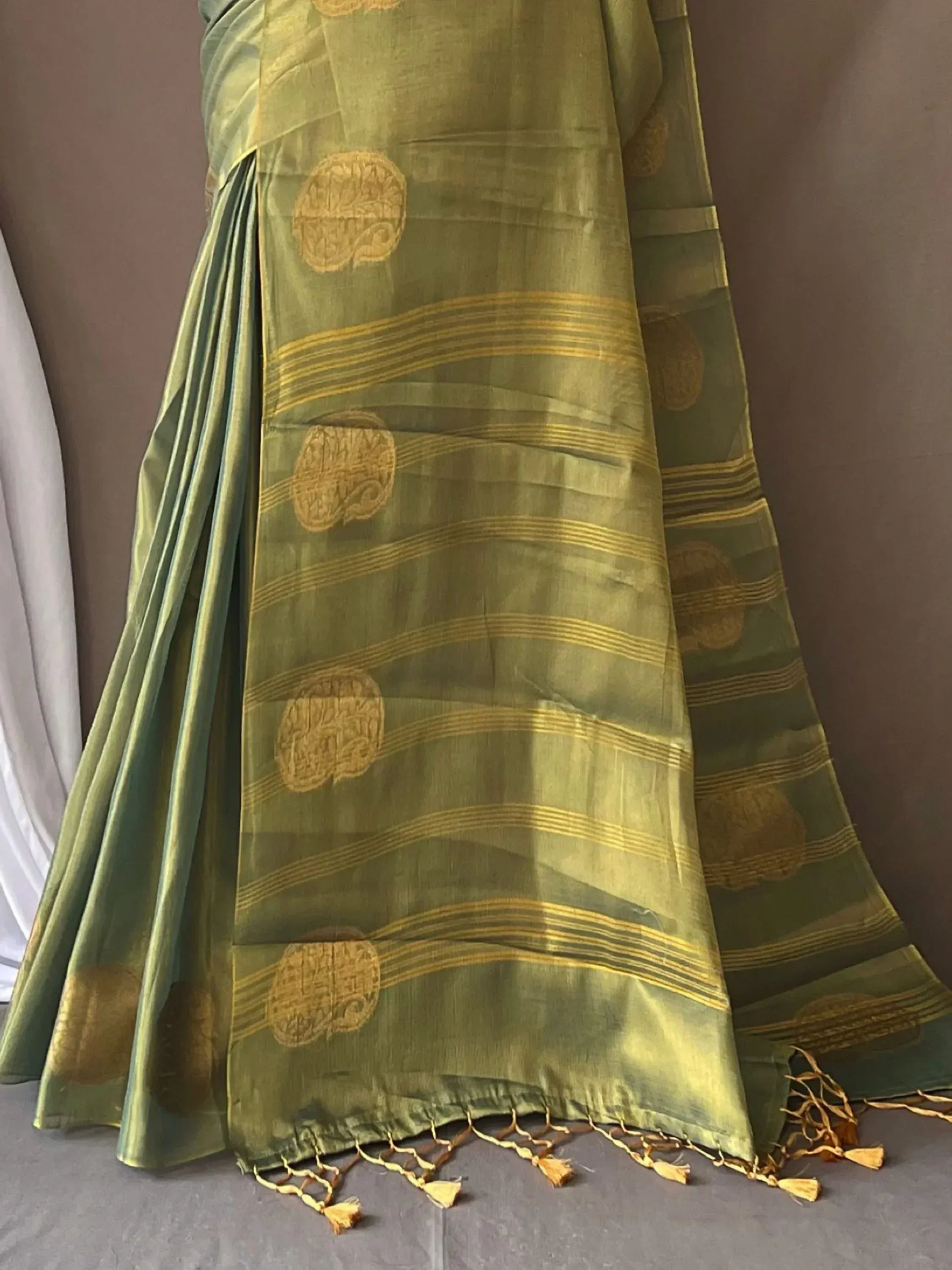 Olive green saree with gold circular motifs and striped border, traditional Indian ethnic wear